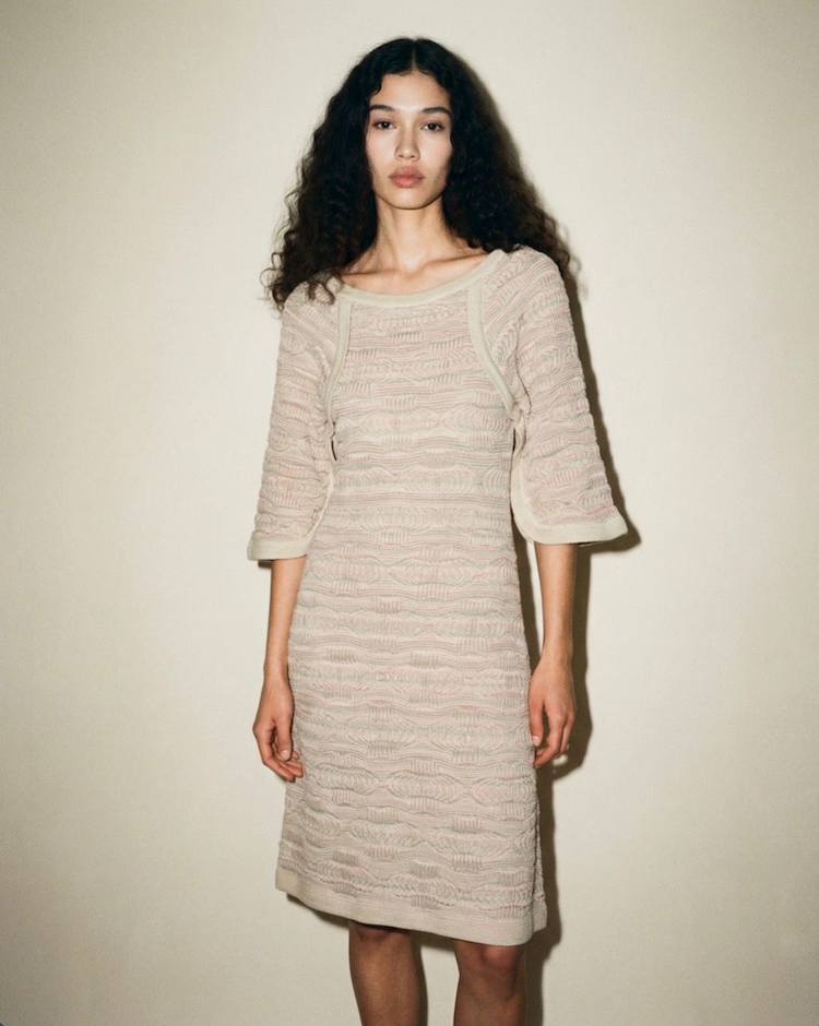 Front view of the Chanel Dubai Tweed knit dress from the Cruise 2015 collection, featuring a scoop neckline and 3D-effect desert beige texture.