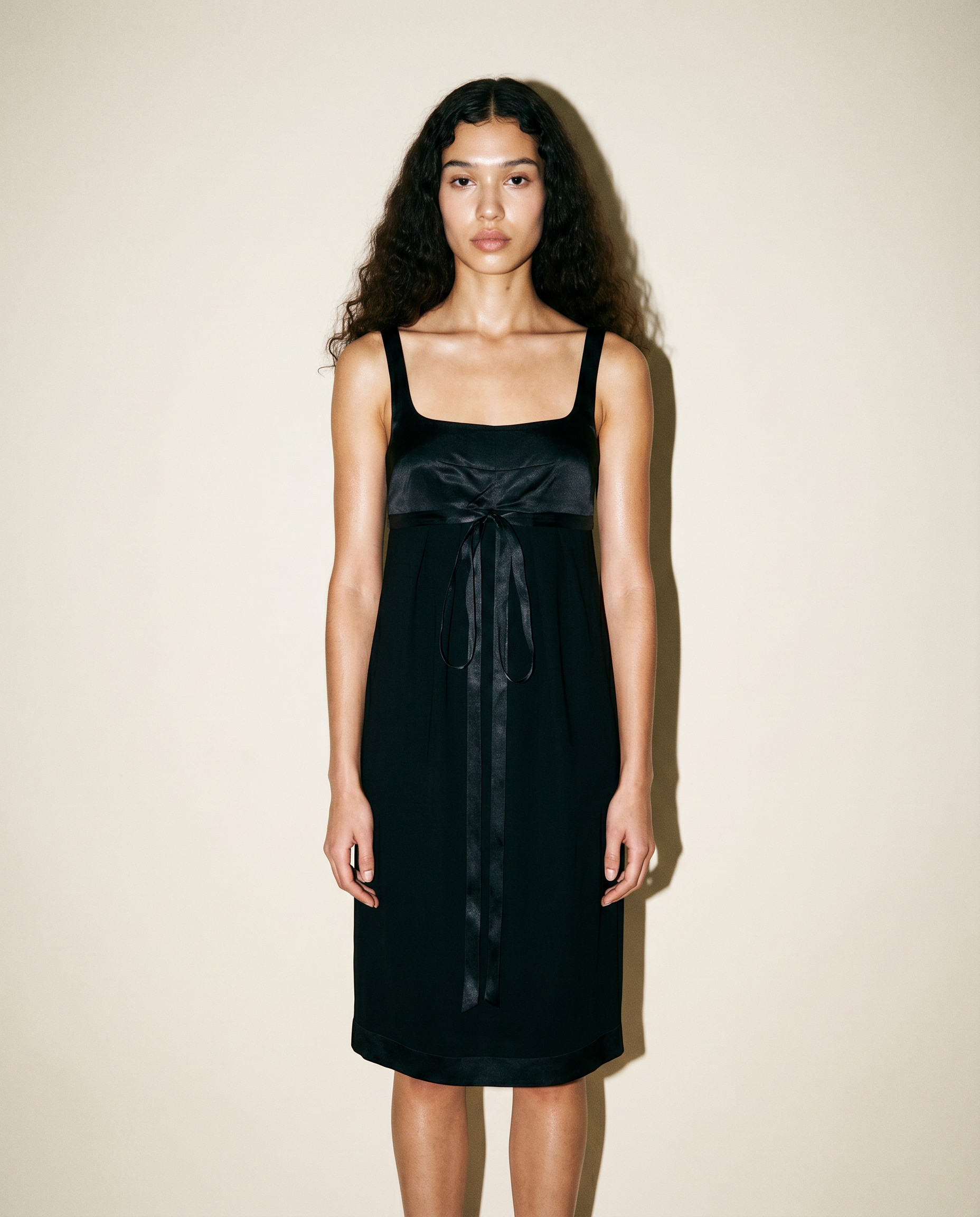 Front view of the archival Chanel Little Black Dress from the Cruise 2010 collection, featuring a square neckline and delicate front ribbon detail.