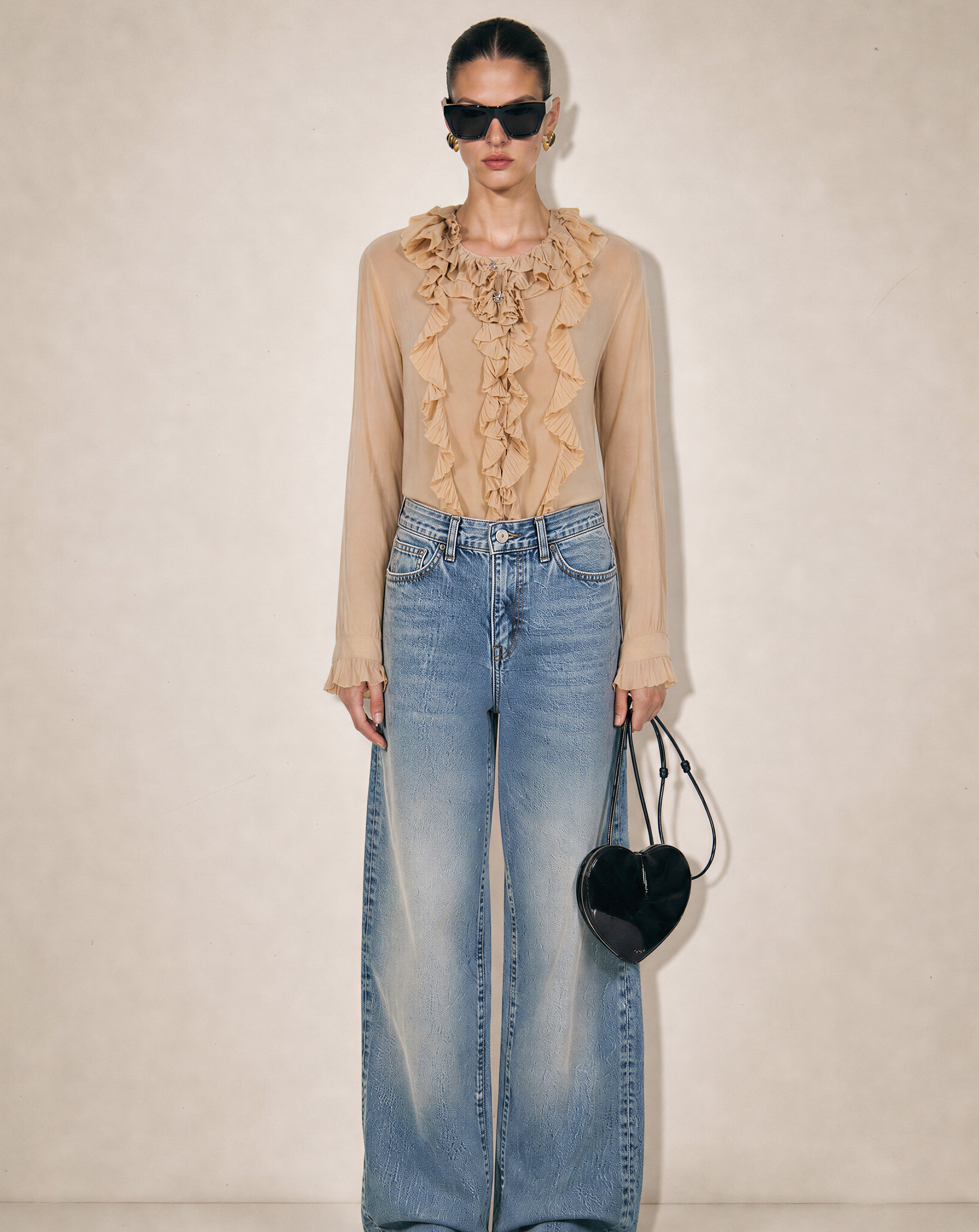 Front view of the Chloé ruffled silk blouse featuring an intricate cascading jabot and a romantic high-neck floral detail in beige.
