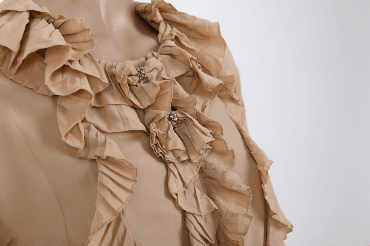 Close-up of the Chloé ruffled silk blouse highlighting the delicate silk-chiffon layers and the Victorian-inspired ruffle craftsmanship.