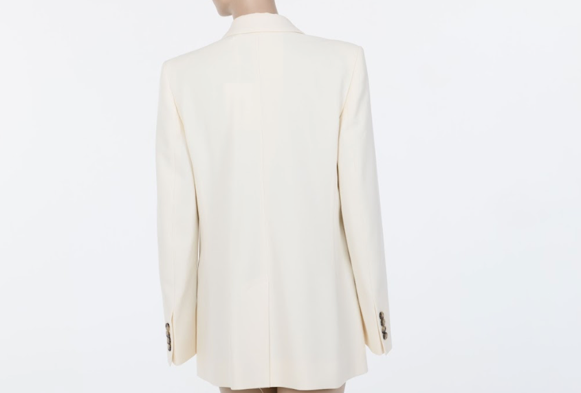 Back view of the FRAME Relaxed Double-Breasted Blazer showing the smooth drape and refined structure of the ivory woven fabric.