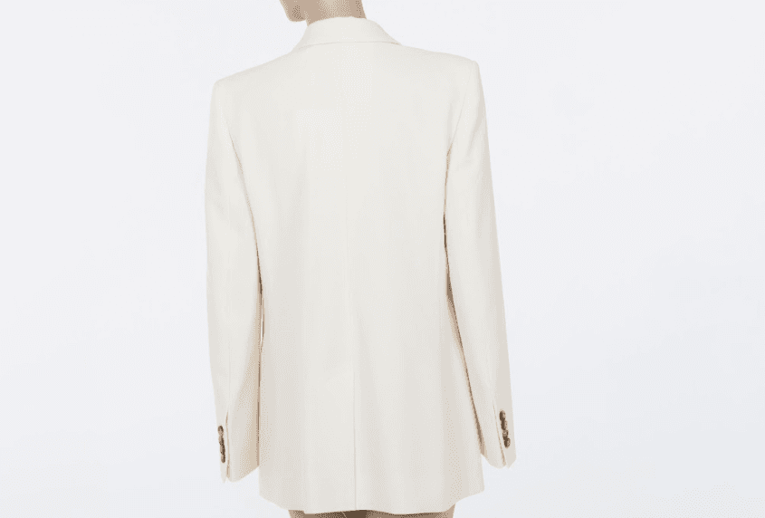 Back view of the FRAME Relaxed Double-Breasted Blazer showing the smooth drape and refined structure of the ivory woven fabric.