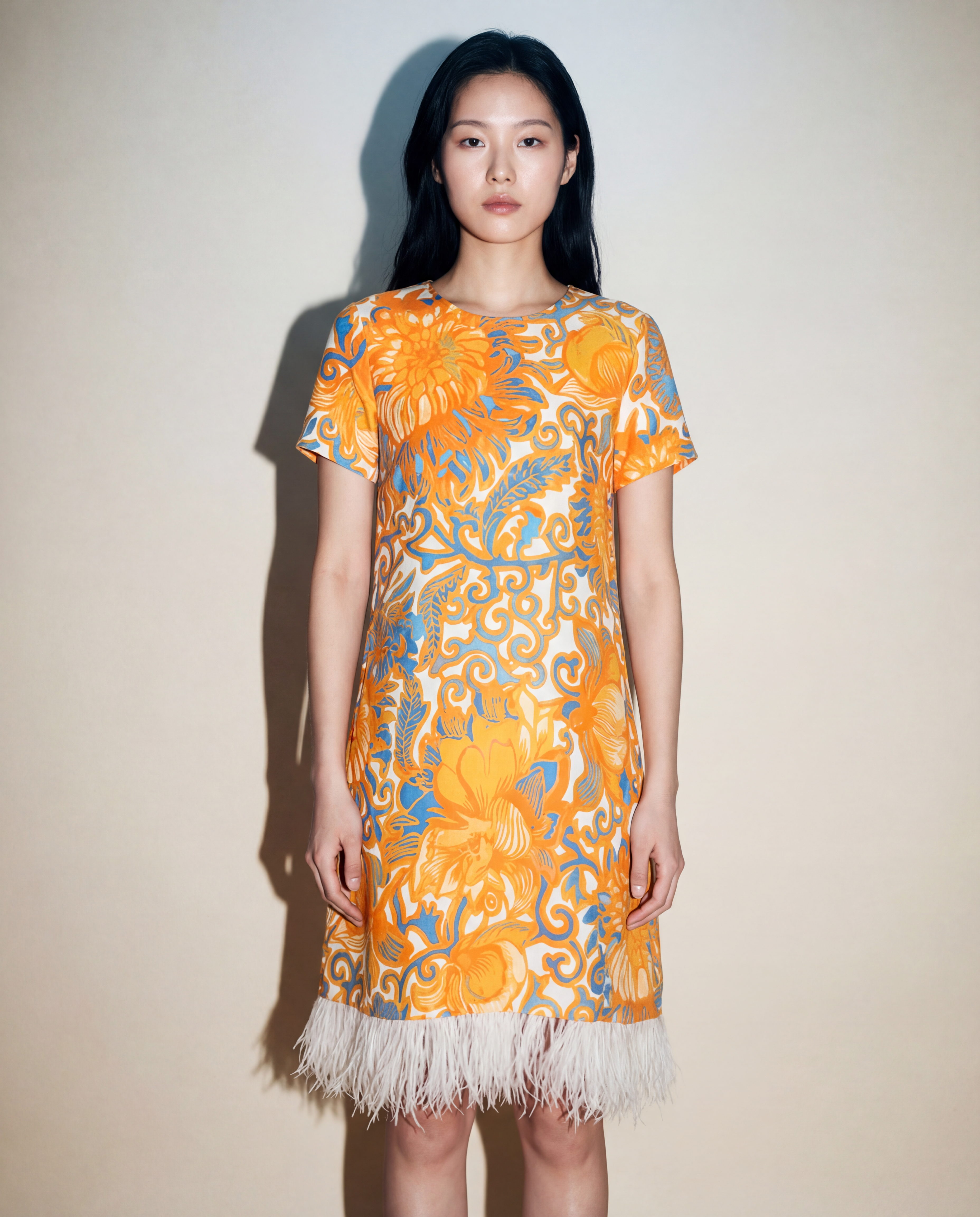 La DoubleJ mini dress with orange and blue floral print and feather hem Mezzanotte Madrid