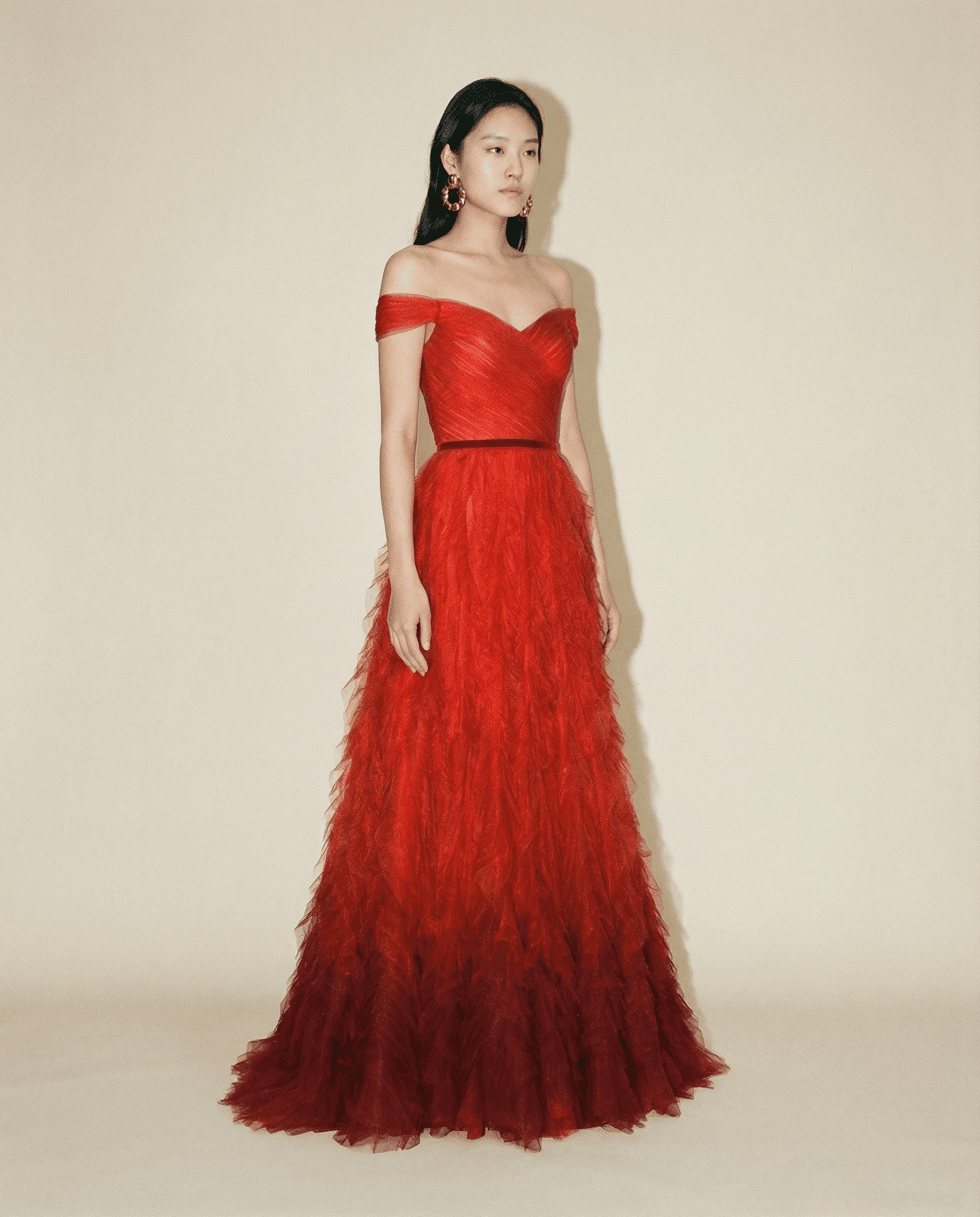 Red gown with velvet waistband and voluminous ruffle skirt