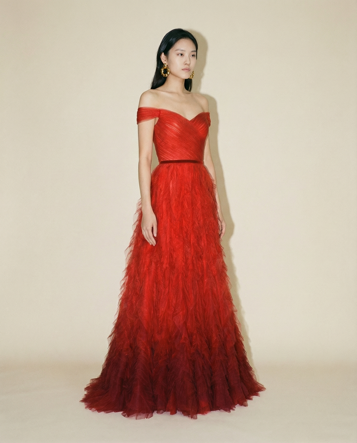 Red gown with velvet waistband and voluminous ruffle skirt