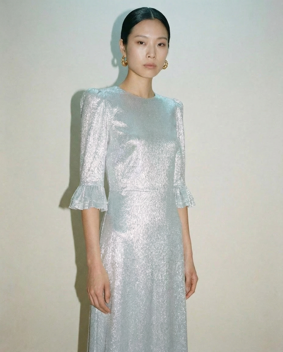 The Vampire’s Wife Falconetti dress in metallic silver with high neckline and fitted silhouette luxury gown