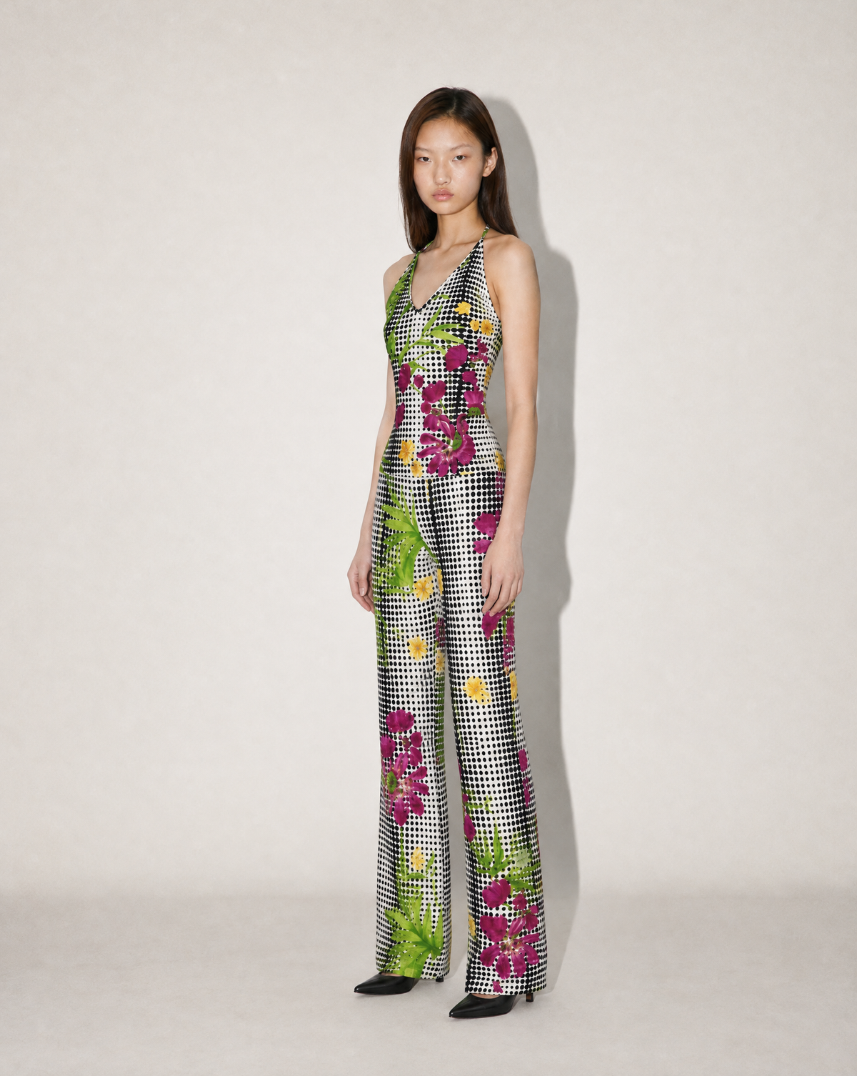 Detail of the bold Versace print, mixing hibiscus flowers, green palm foliage and gingham checks. A collectible 1990s designer piece for Gianni Versace collectors and vintage fashion lovers.