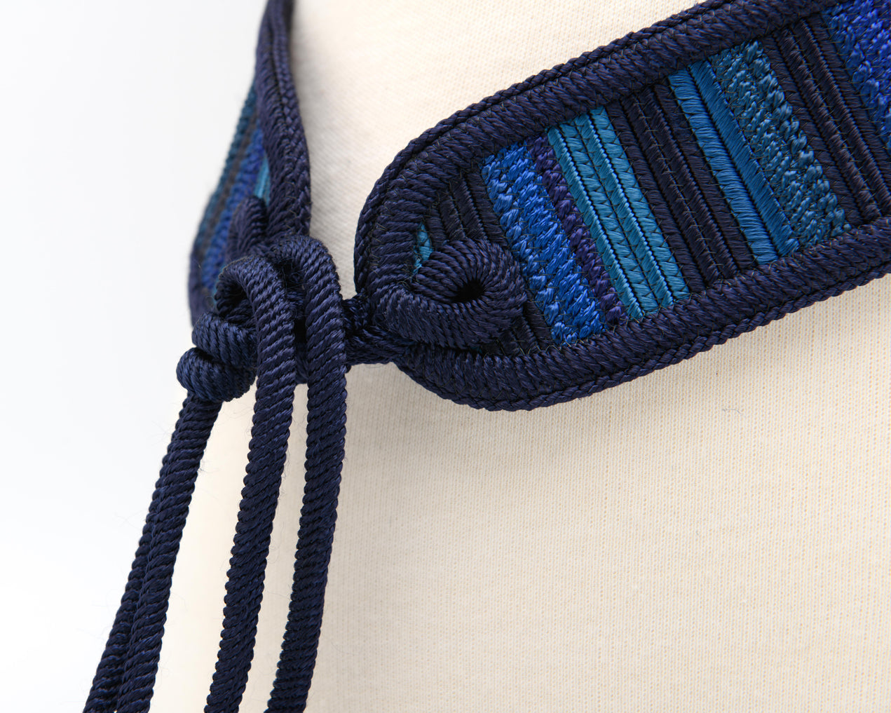 1990s woven textile belt in tonal blue with braided tie closure and decorative tassel detail