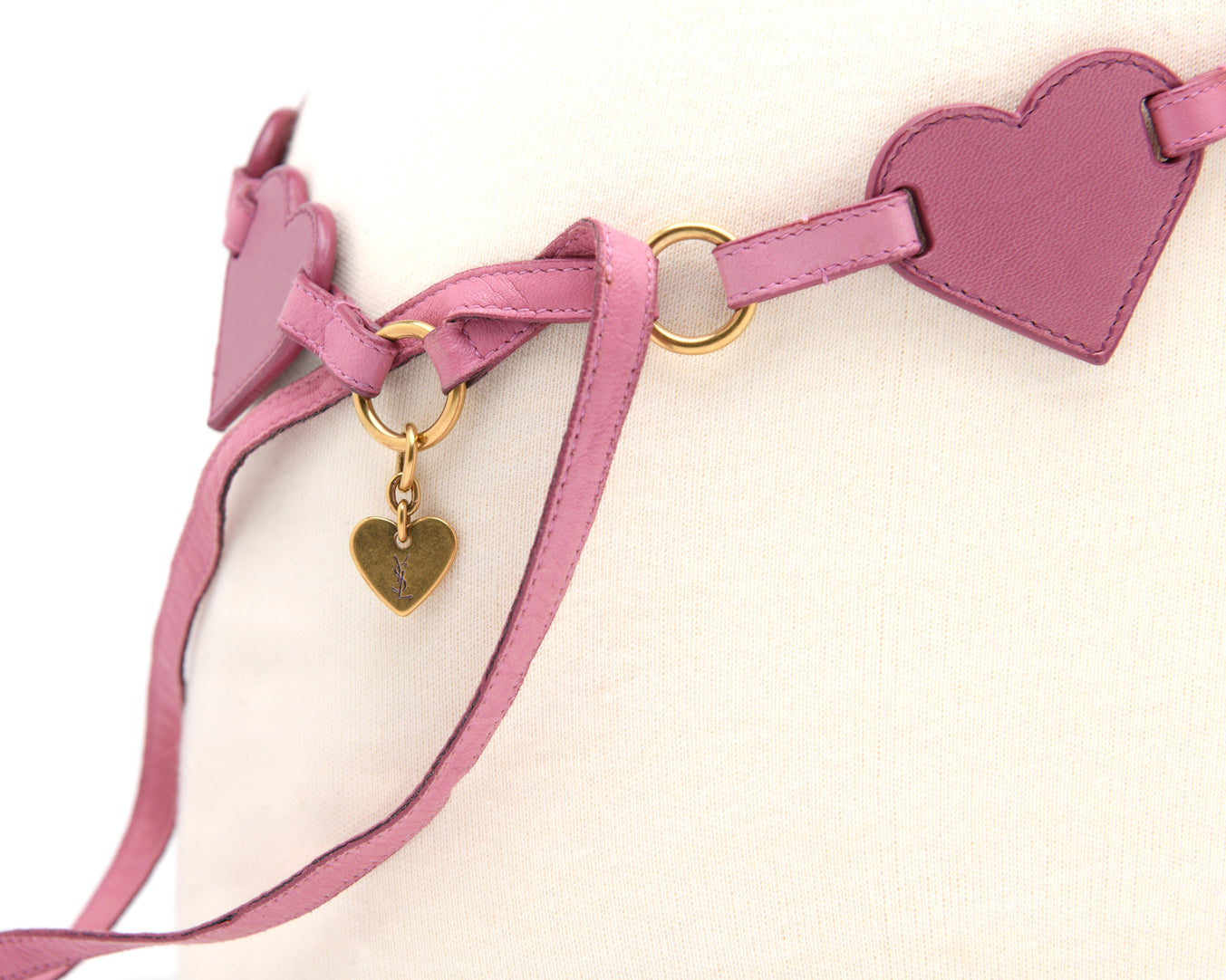 Yves Saint Laurent pink leather heart chain belt with gold rings and dangling YSL charm detail