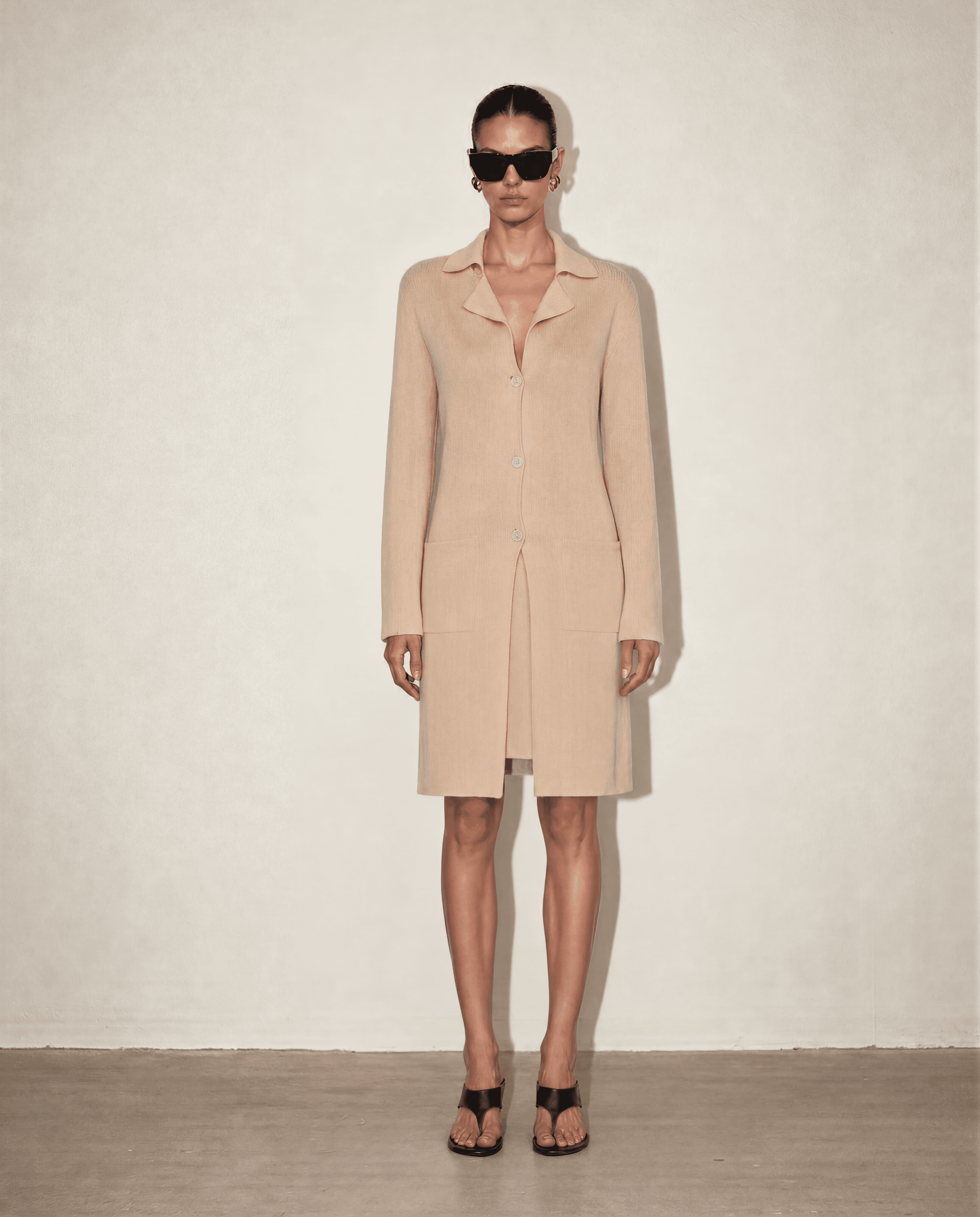 Front view of the Malo knit set featuring the silk-cotton V-neck slip dress and matching longline knit coat in a timeless nude beige.