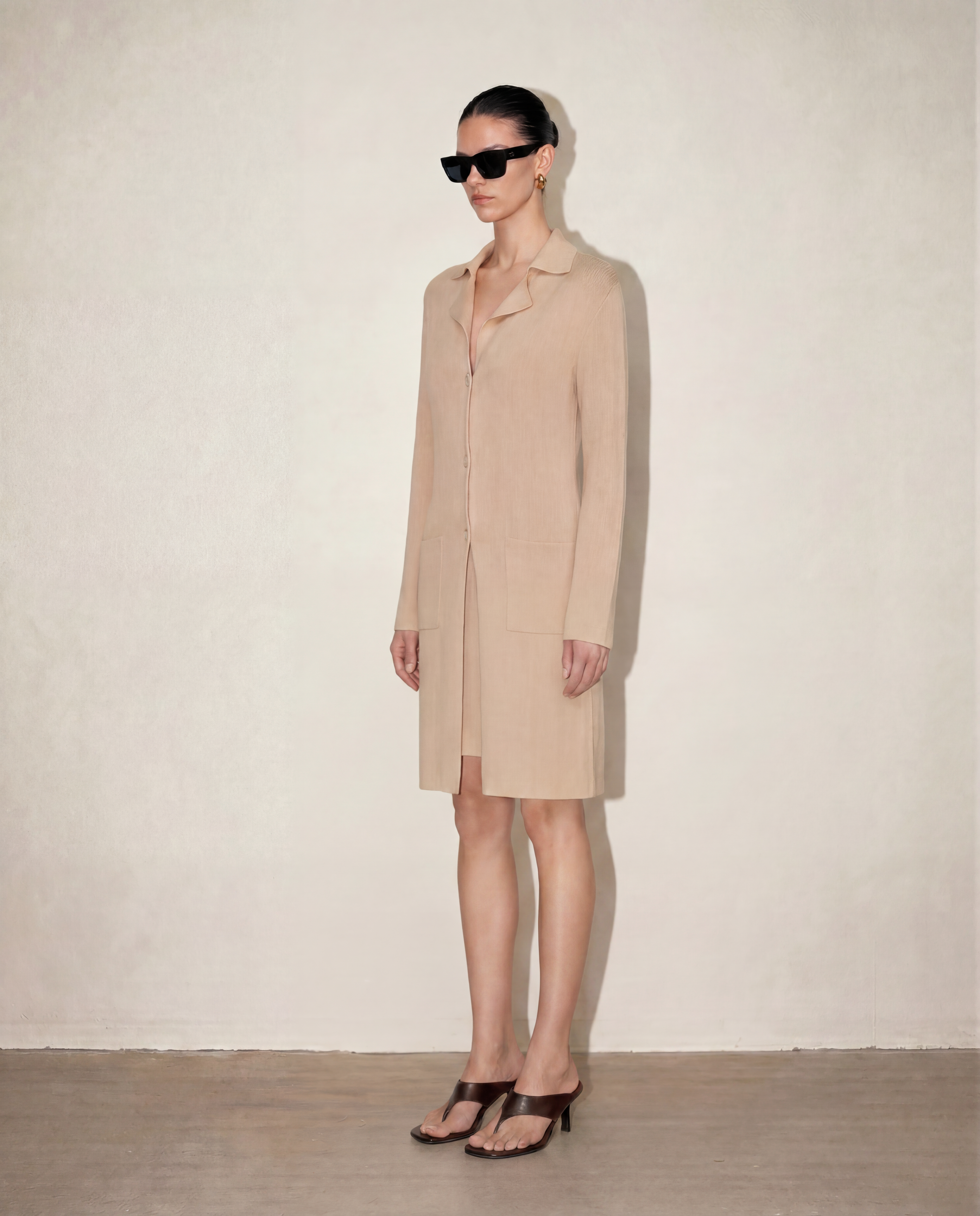 Side profile of the Malo knit set showing the body-skimming silhouette of the dress paired with the elegant drape of the longline cardigan.