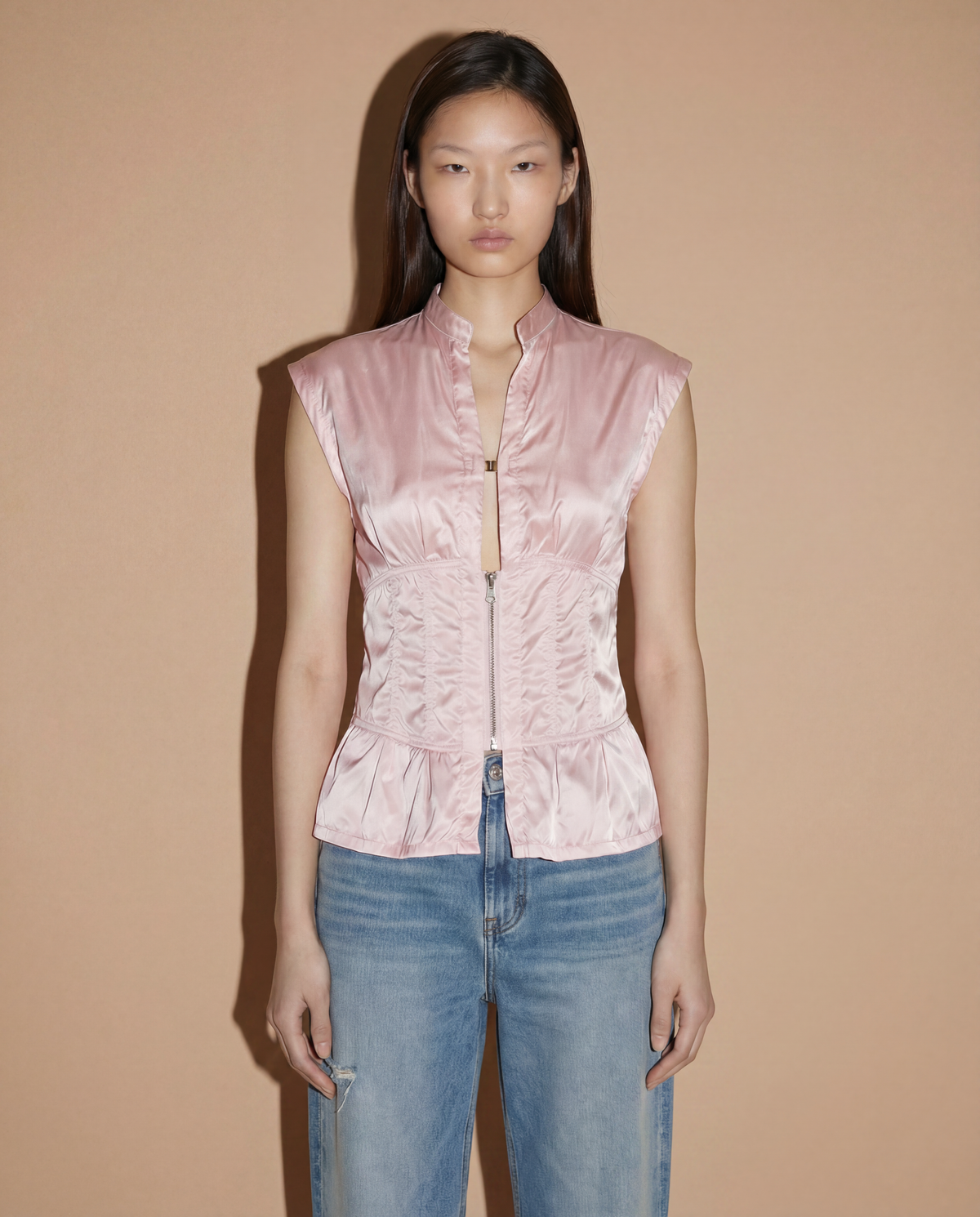 Front view of the Prada Sport corset-style top in blush pink featuring a structured zip closure and minimalist 90s silhouette.
