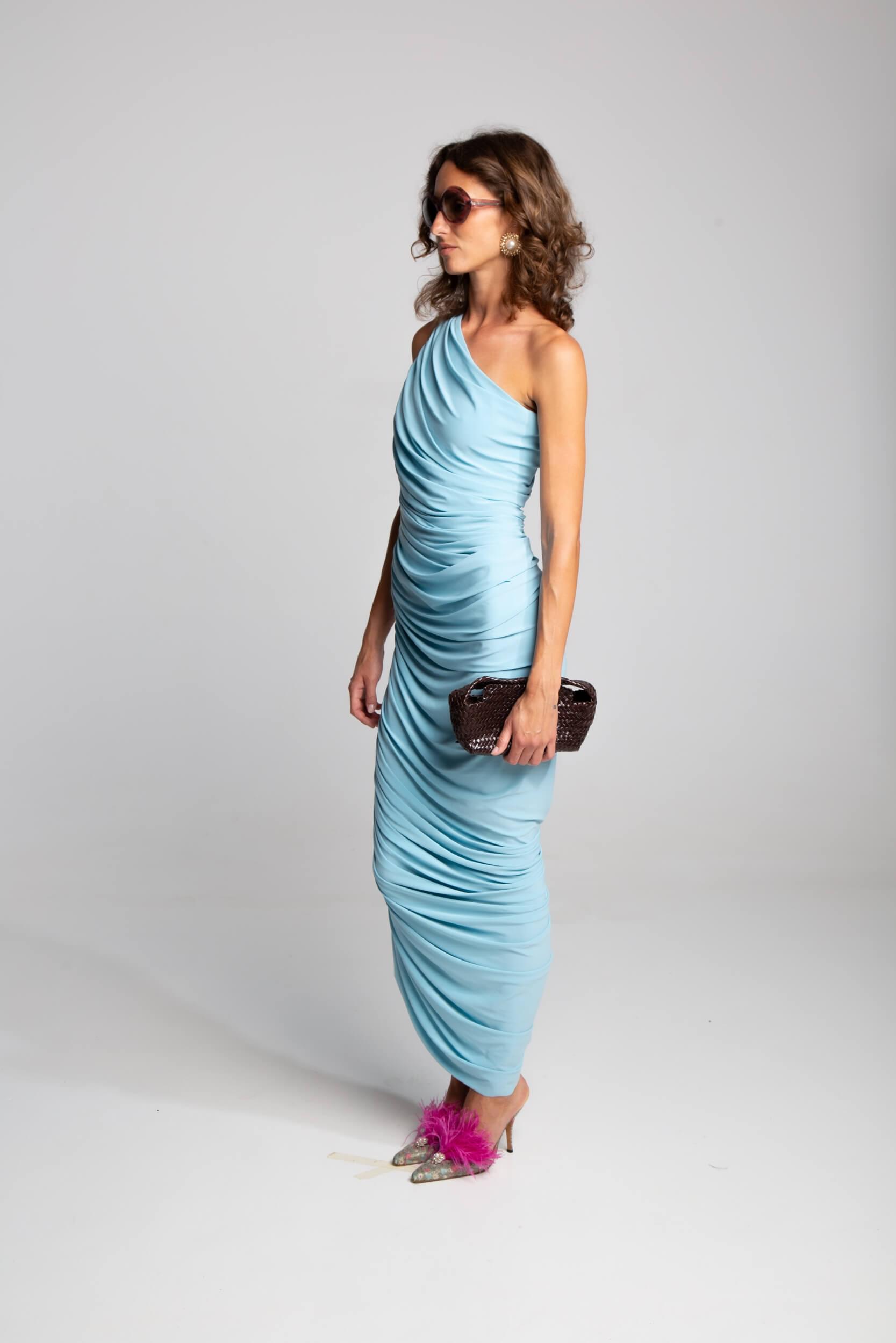 Ruched evening gown with single shoulder neckline and fluid drape