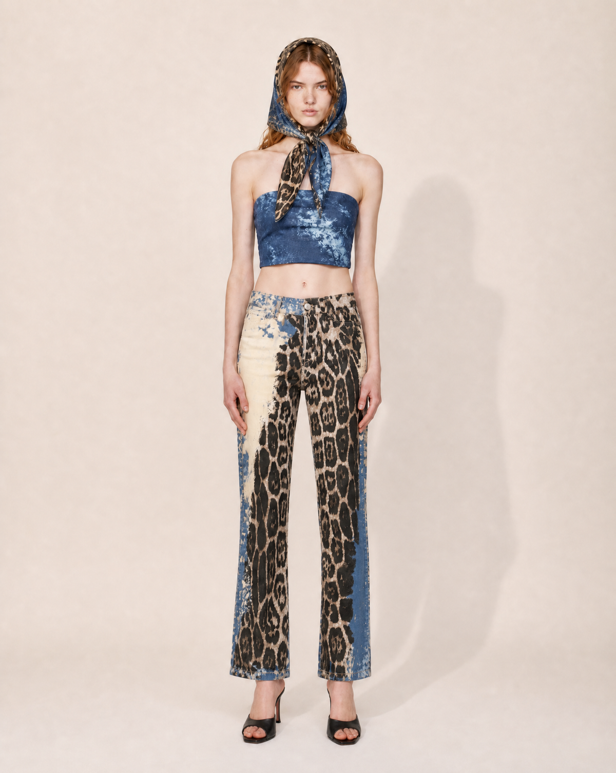 Shop this collectible early 2000s Roberto Cavalli set at Mezzanotte Vintage. The Angels print palazzo trousers come with the original matching headscarf, featuring leopard motifs over a faded blue denim-effect print.