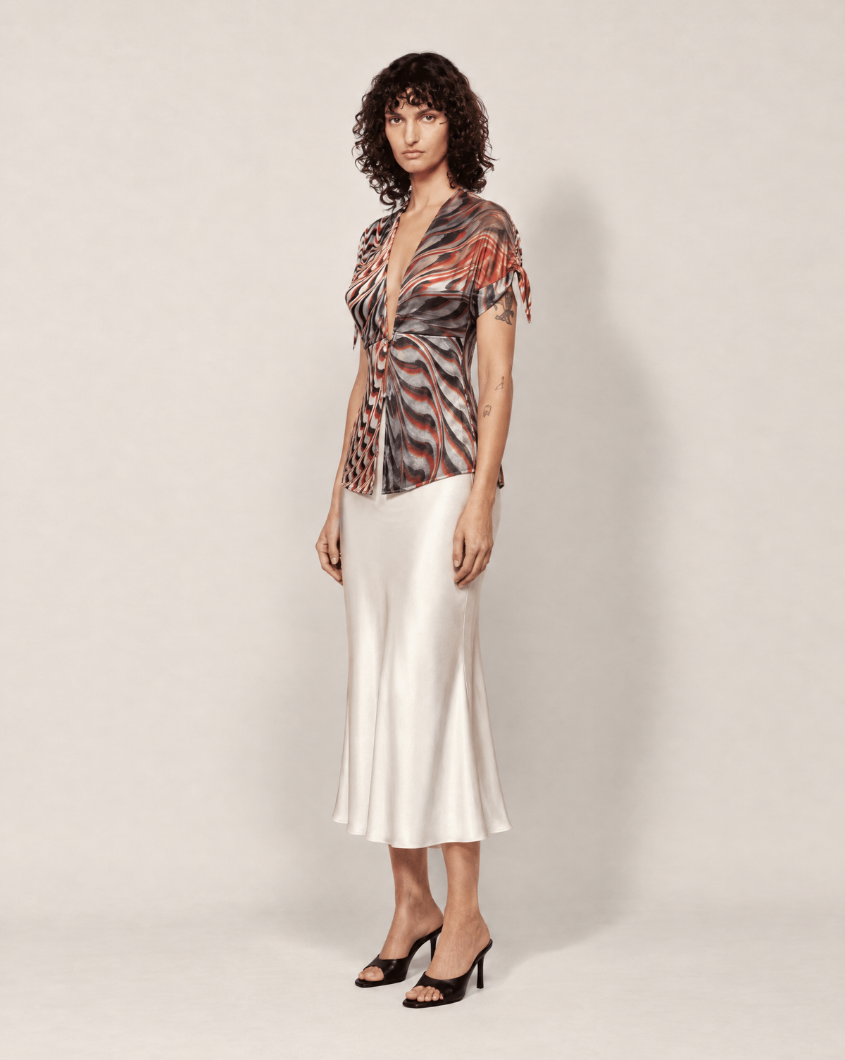 Early 2000s Roberto Cavalli sheer silk shirt with a bold abstract print in red, burgundy, charcoal, black and ivory. Shop this archival Y2K designer piece at Mezzanotte Vintage, or enquire about rental and stylist pulls in Madrid and across Europe.