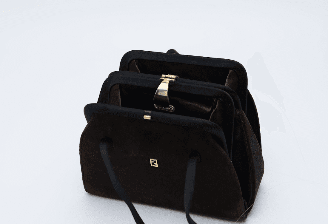 Brown velvet Fendi top handle bag with gold metal clasp and structured silhouette Mezzanotte Madrid