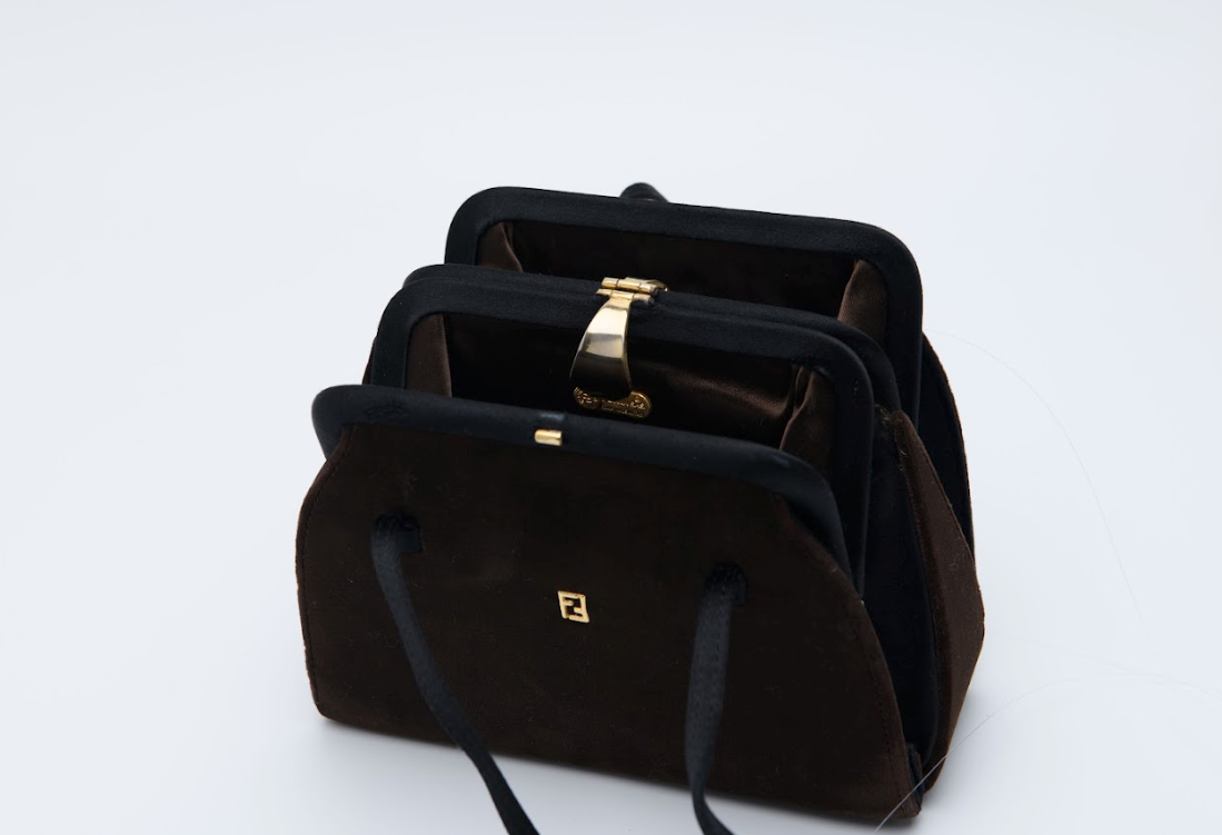 Brown velvet Fendi top handle bag with gold metal clasp and structured silhouette Mezzanotte Madrid