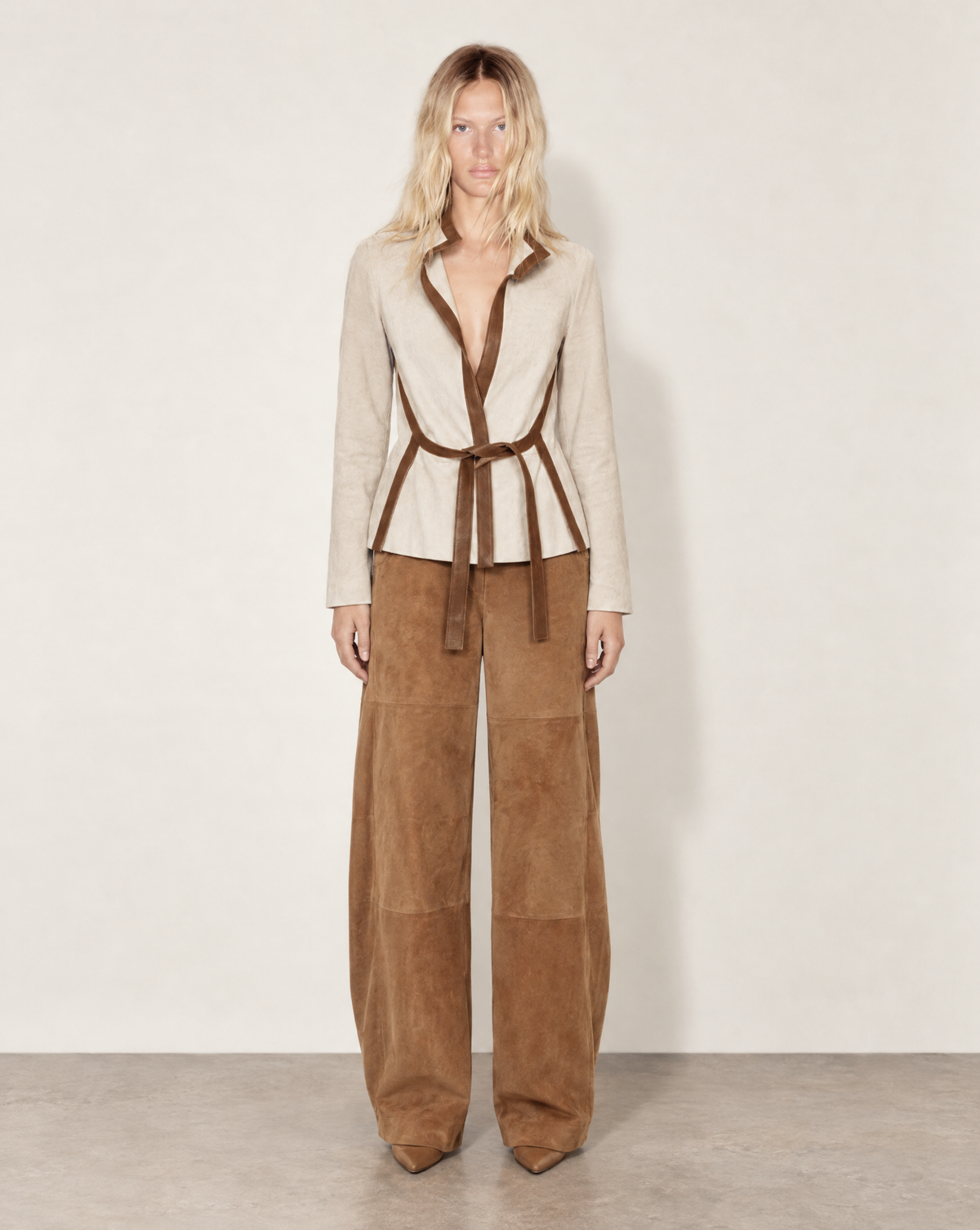 Open-front Valentino wrap jacket with an integrated leather tie belt to define the waist. Its elongated panels and standing collar create a clean, tailored silhouette buy at Mezzanotte Archival