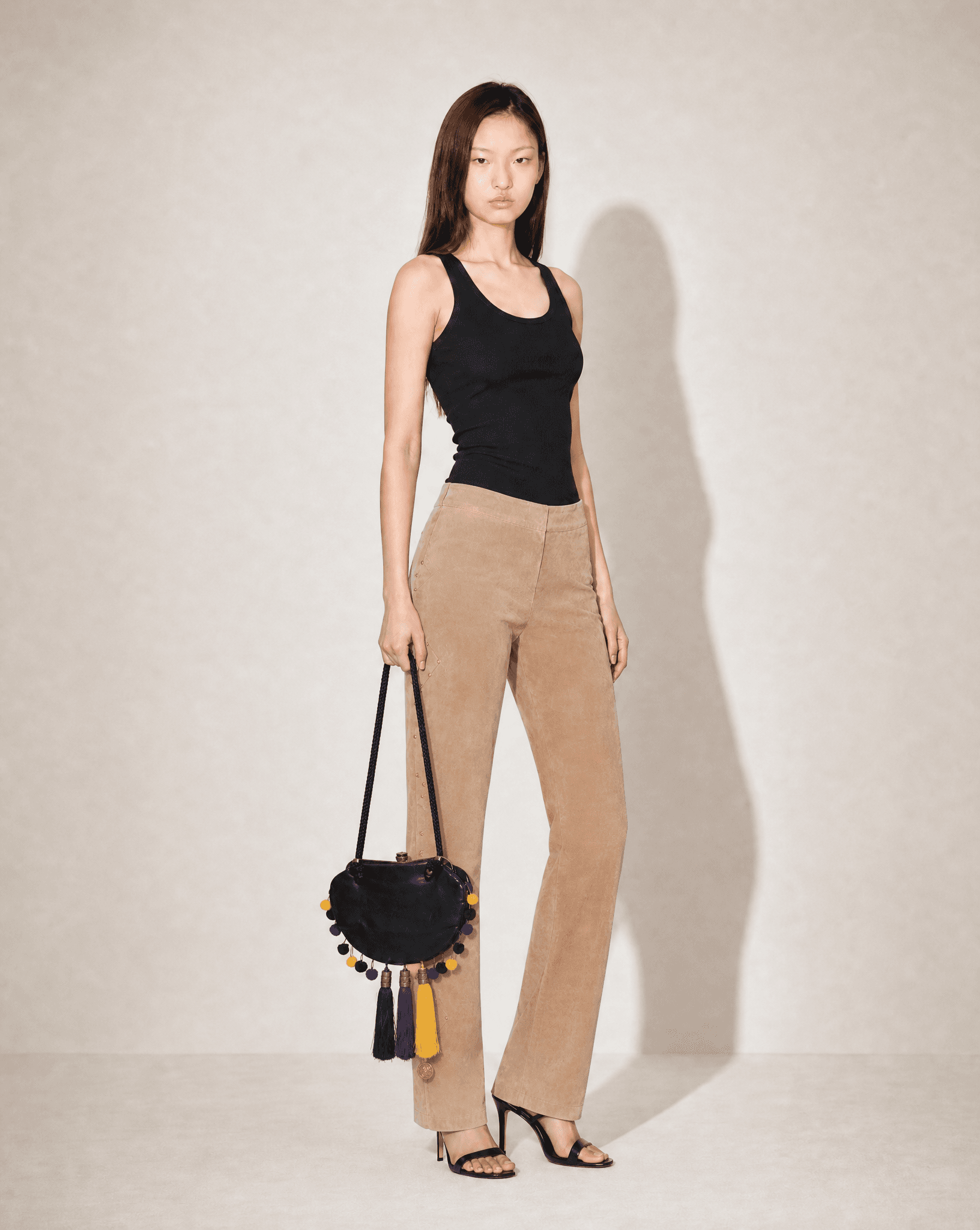 Iconic archival John Galliano 2007 bag with colorful tassels and pom-poms, available at Mezzanotte Madrid.