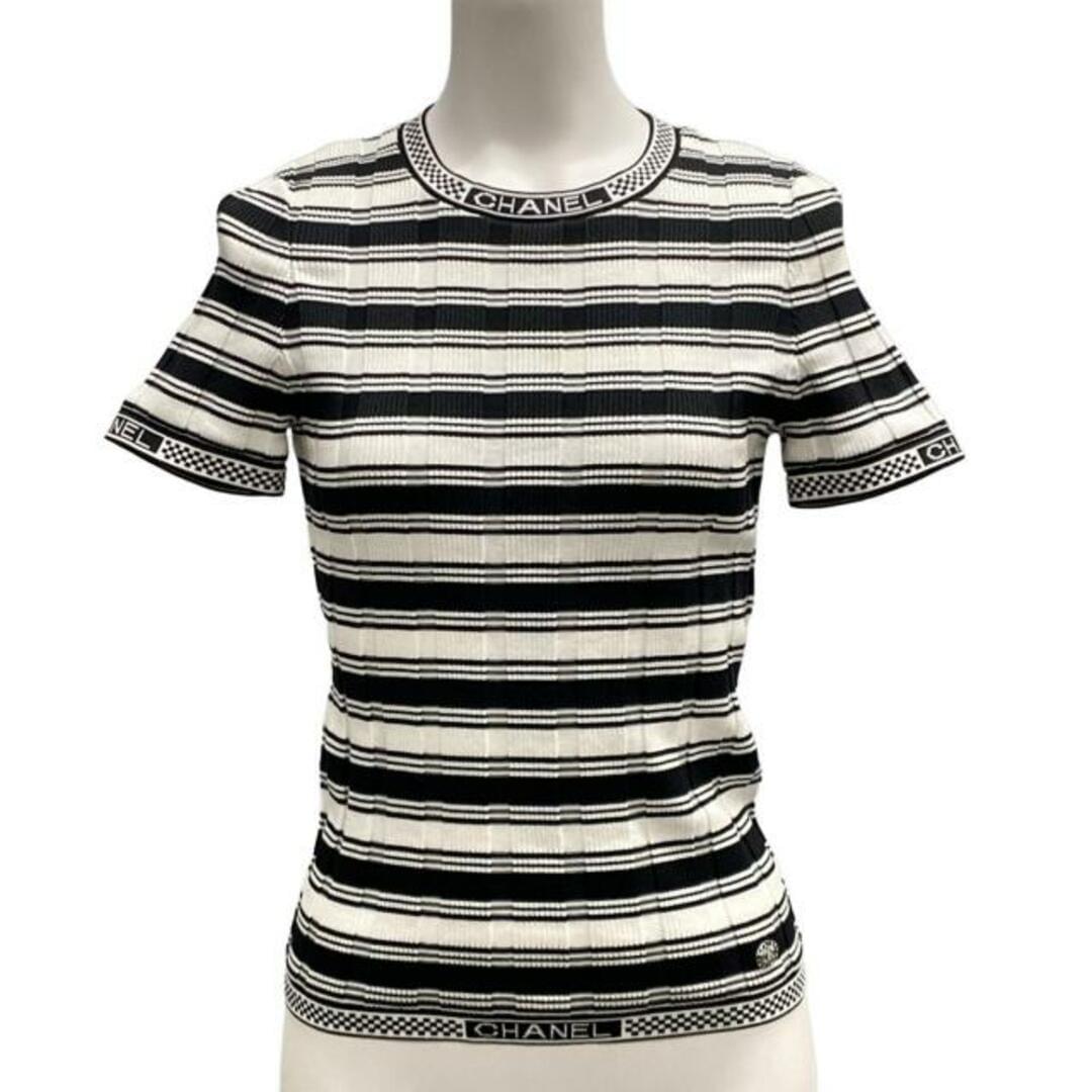 Close-up of the Chanel logo trim and ribbed knit construction on the black and white striped top.