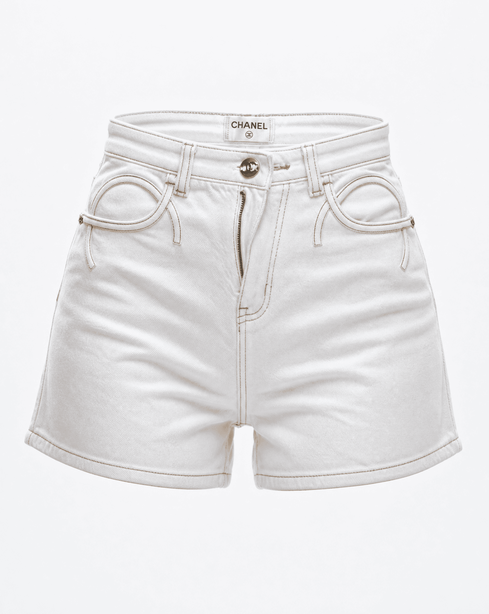 Close-up of the signature interlocking pocket design and gold-tone button on Chanel white denim shorts.