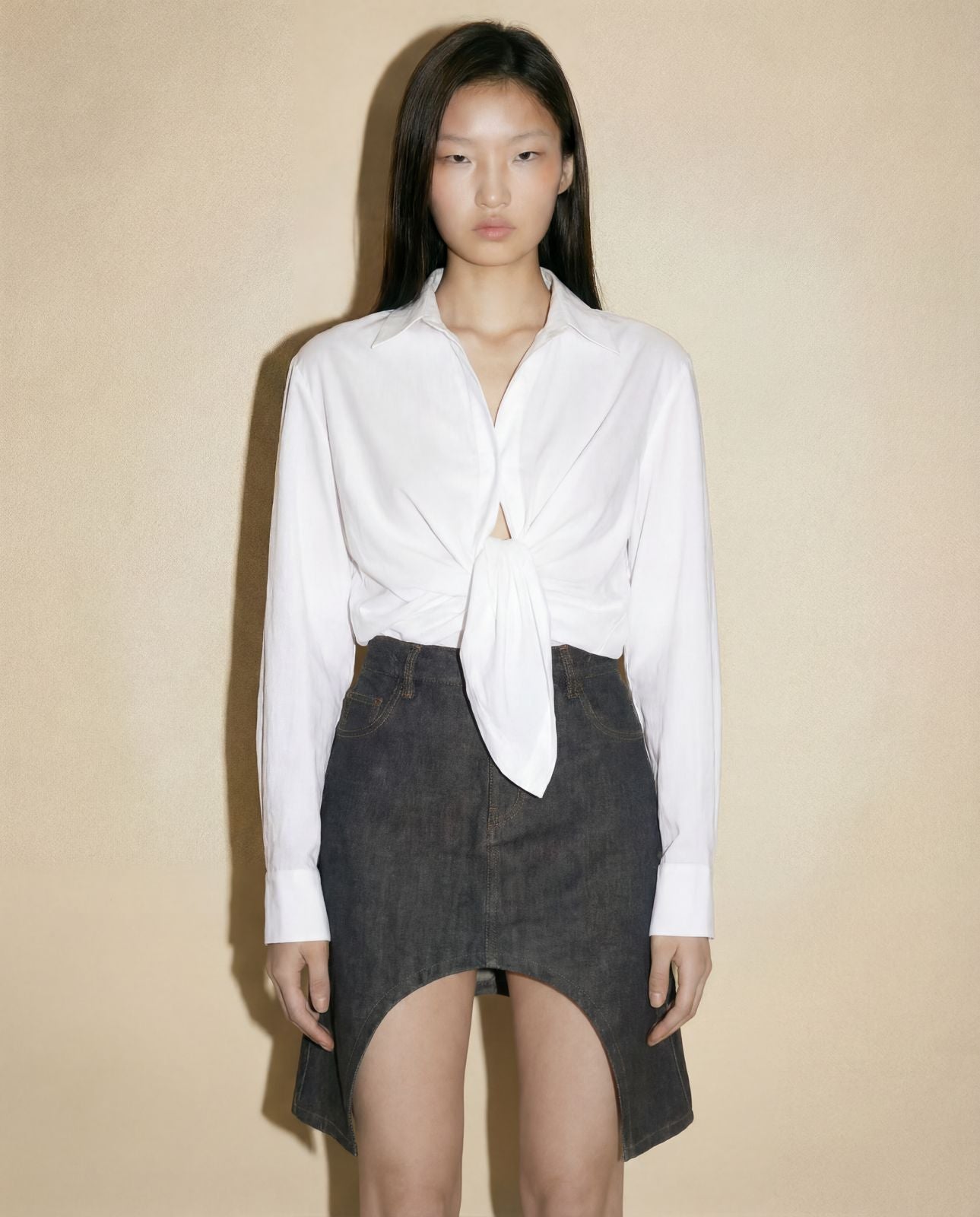 Contemporary Courrèges asymmetric cut-out dark indigo denim mini skirt, available at Mezzanotte Madrid.