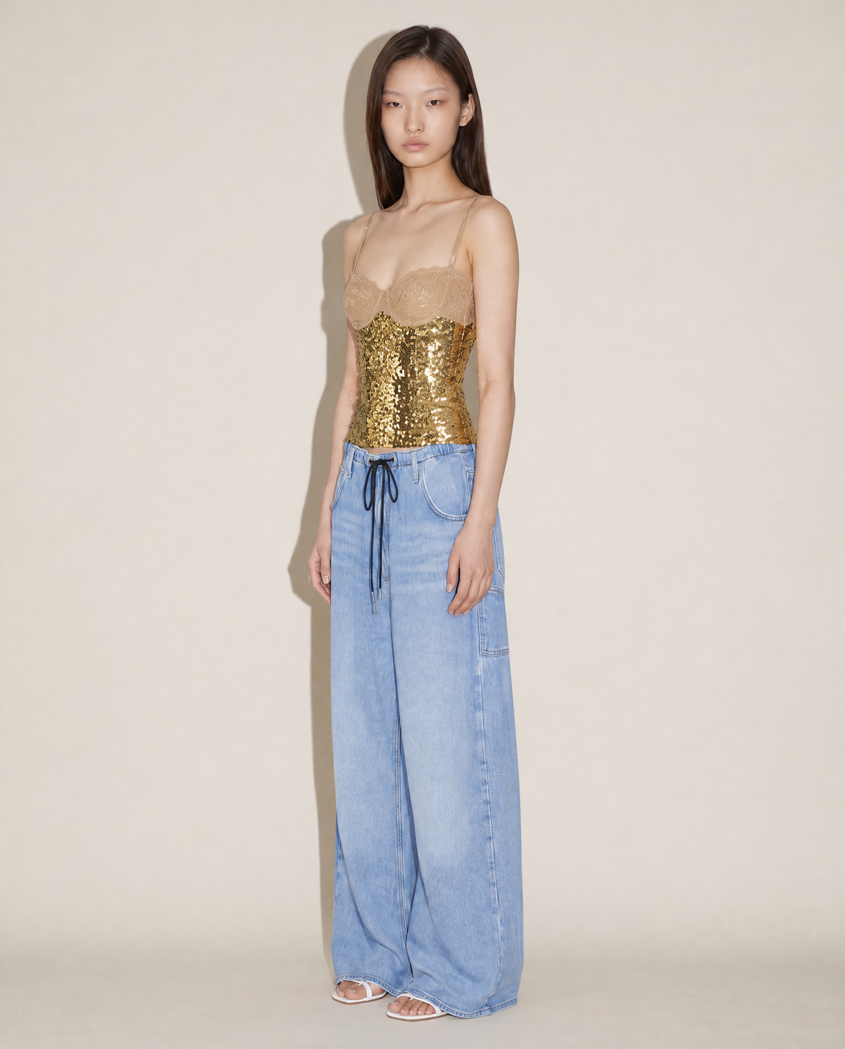 Archival Dolce & Gabbana early 2000s gold sequin corset styled on model. Rent in Madrid or buy across Europe at Mezzanotte.
