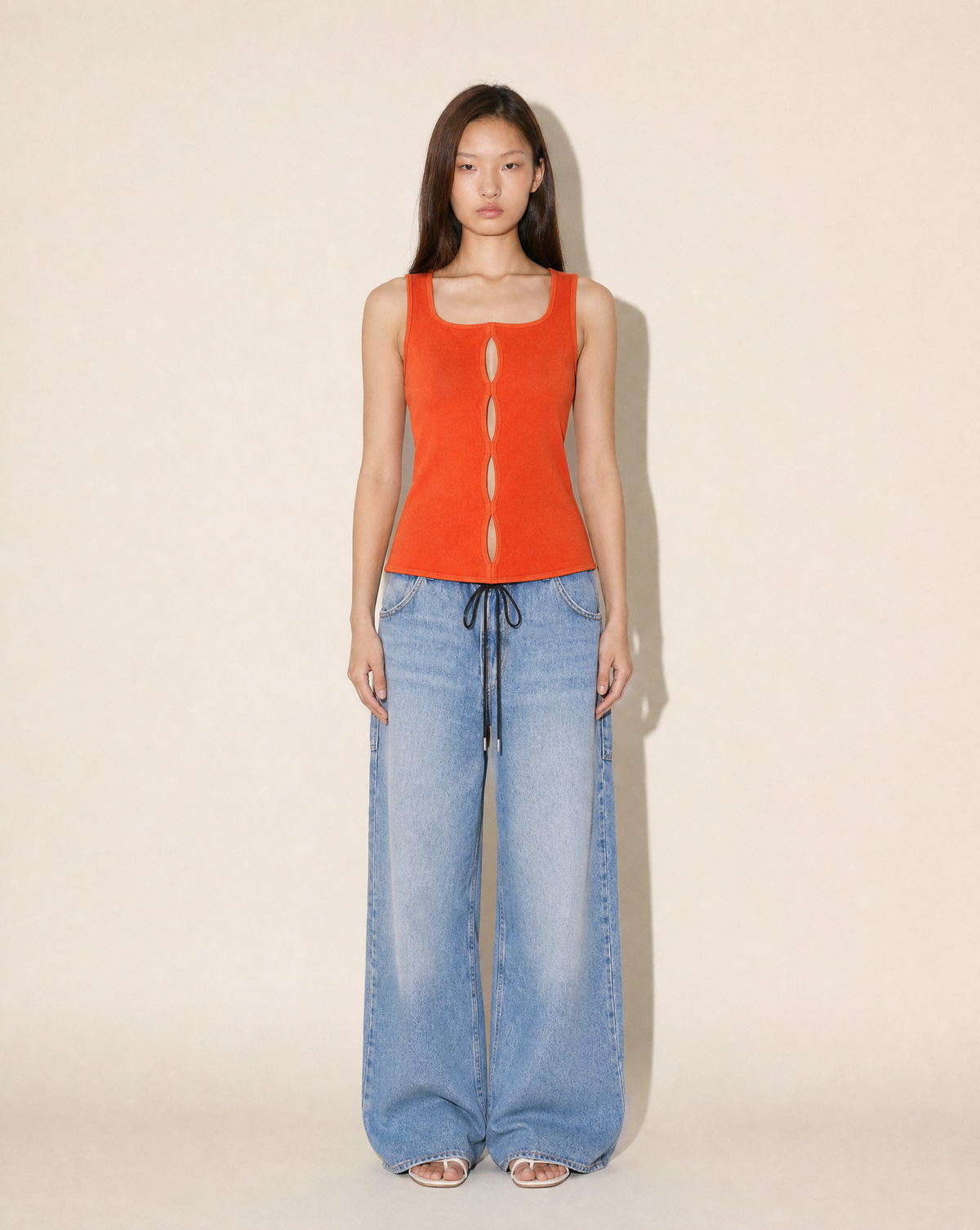 Gianni Versace 1990s coral knit top with architectural cut-outs, available to rent in Madrid or buy across Europe at Mezzanotte.