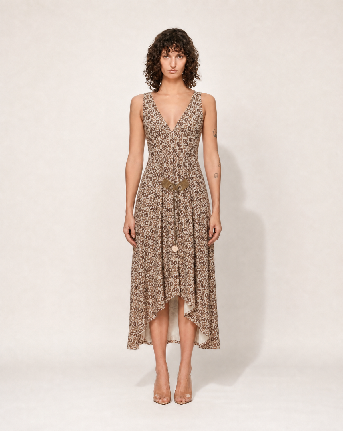 Archival Gucci by Tom Ford silk dress featuring the iconic GG monogram and horsebit tassel detail, available for authenticated purchase and luxury rental across Europe from Mezzanotte.