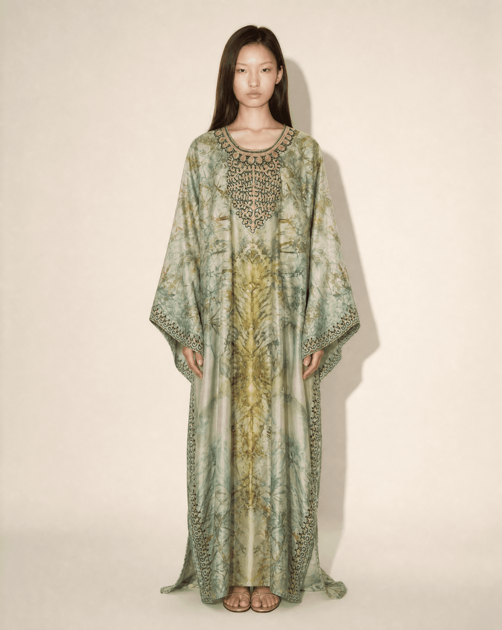 Vintage embellished silk botanical print kaftan with embroidered neckline in sage green tones, available for purchase and luxury rental across Europe from Mezzanotte.