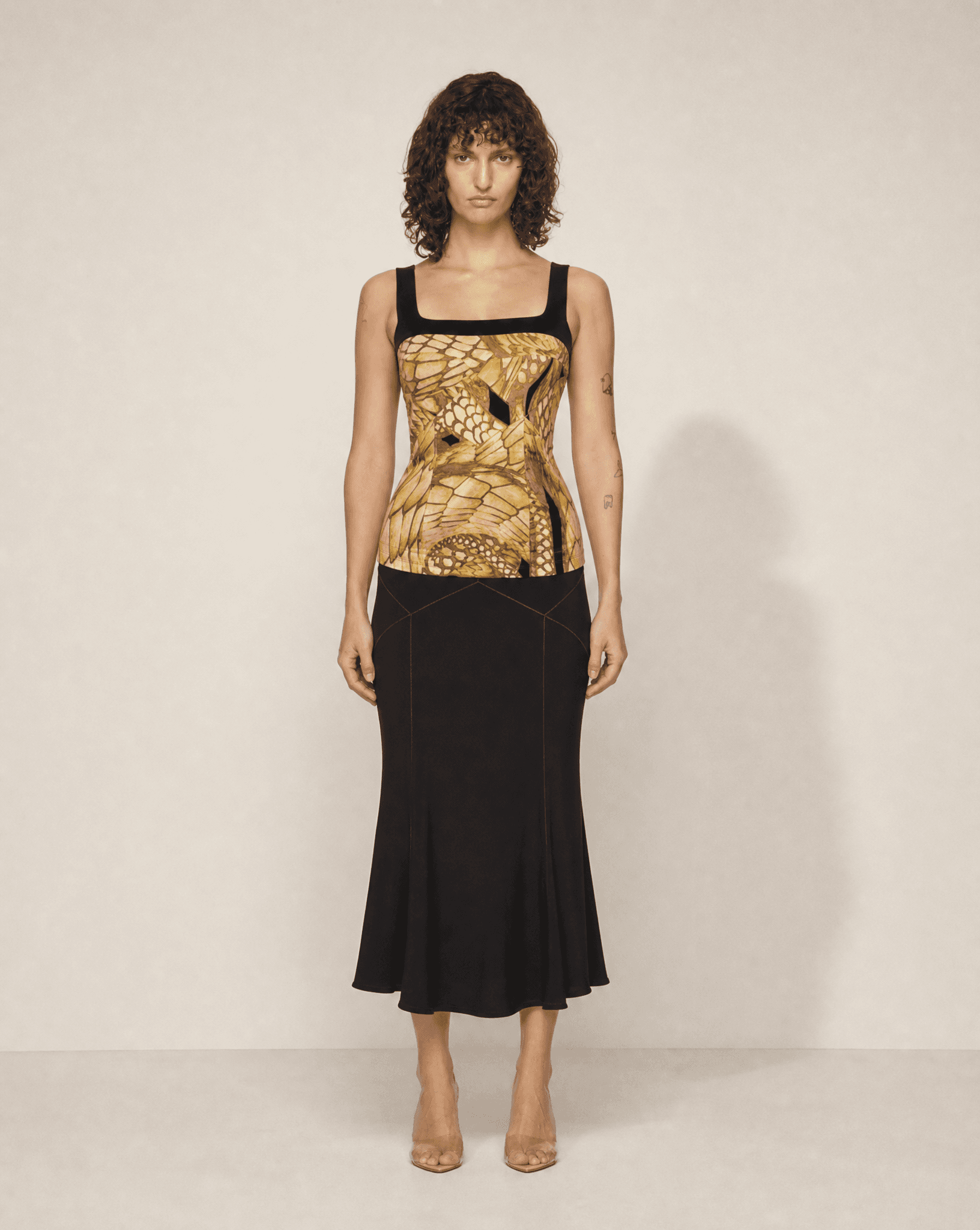 Vintage Roberto Cavalli three-piece skirt suit featuring a matching animal print corset top, tailored blazer and black flared skirt, available for purchase and luxury rental across Europe from Mezzanotte.