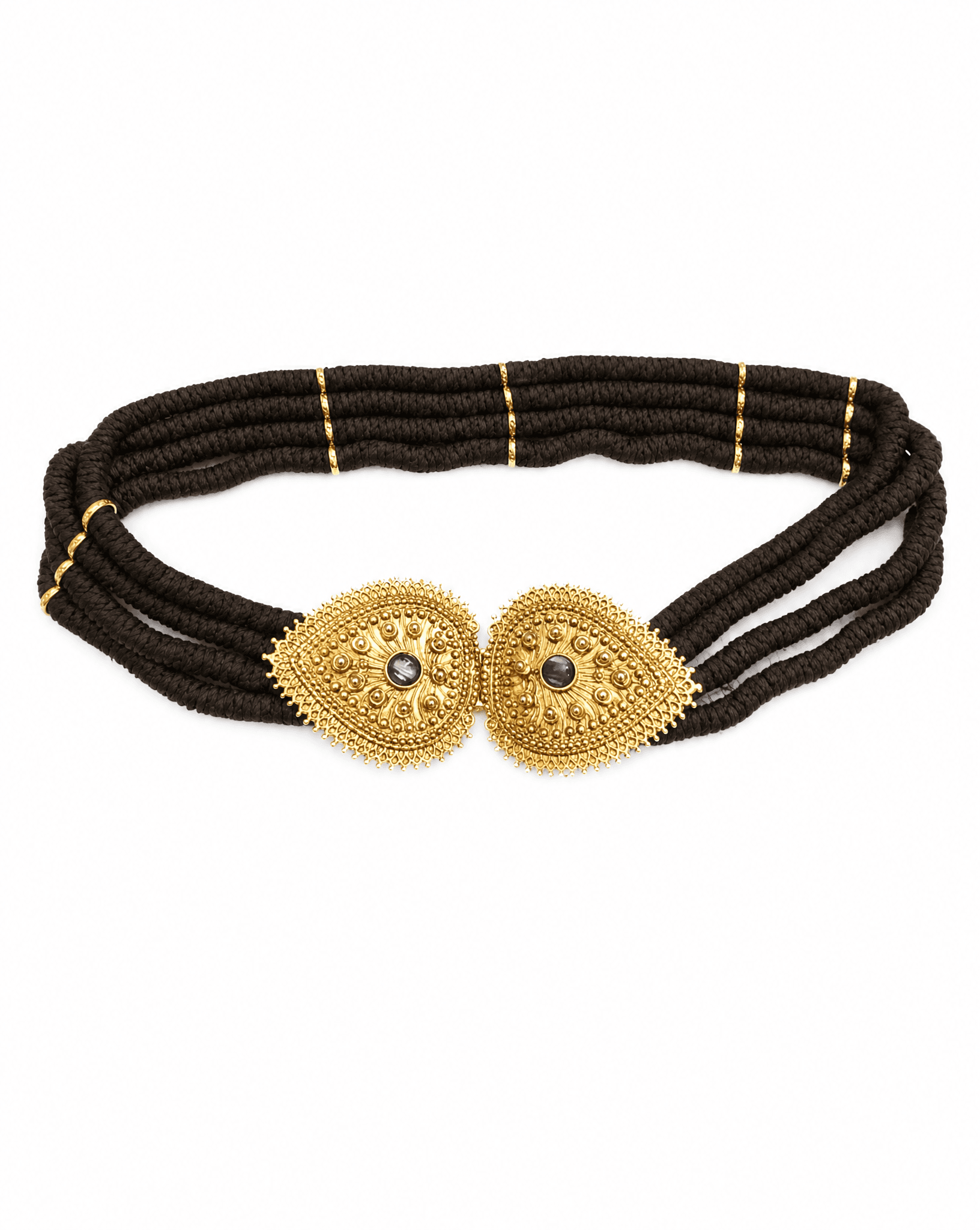 Detail view of the intricate gold-tone filigree buckle on an archival YSL belt curated by Mezzanotte.