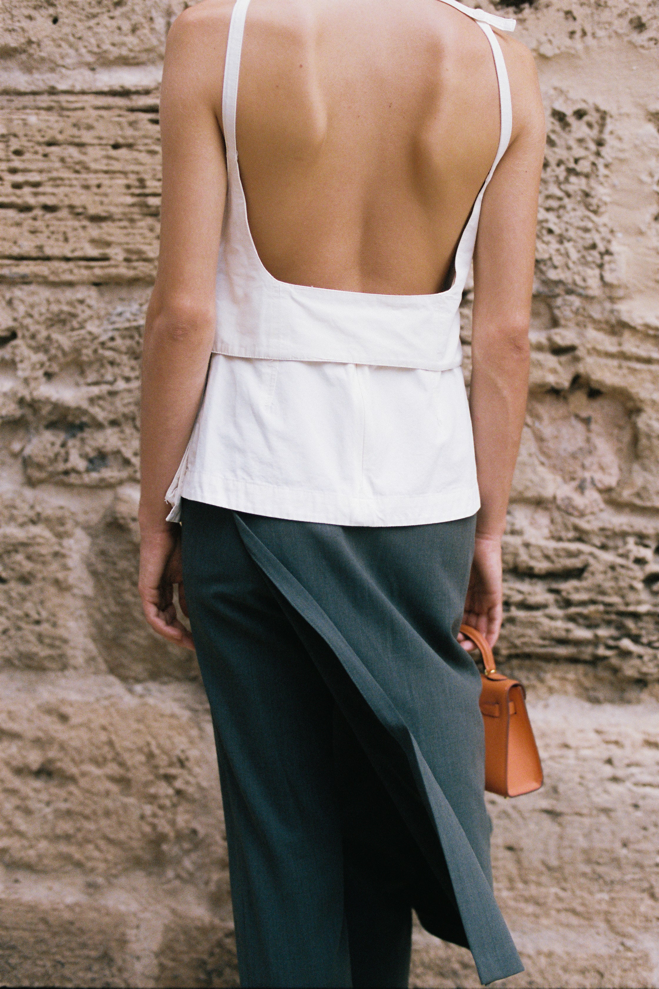 White designer halter top with lapel detail and fitted waist modern tailoring