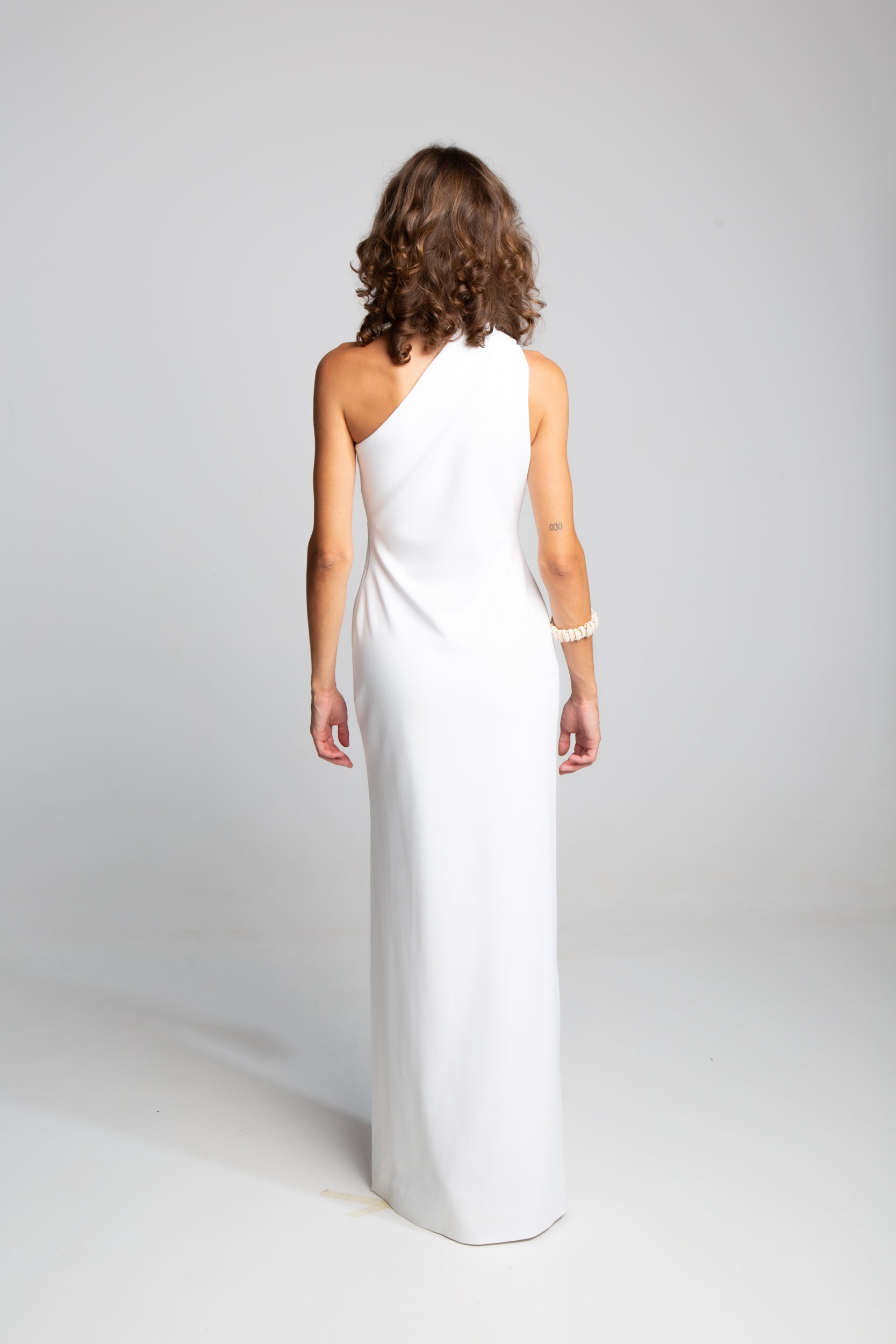 Minimalist white evening dress with asymmetric neckline and tailored column fit Solace London