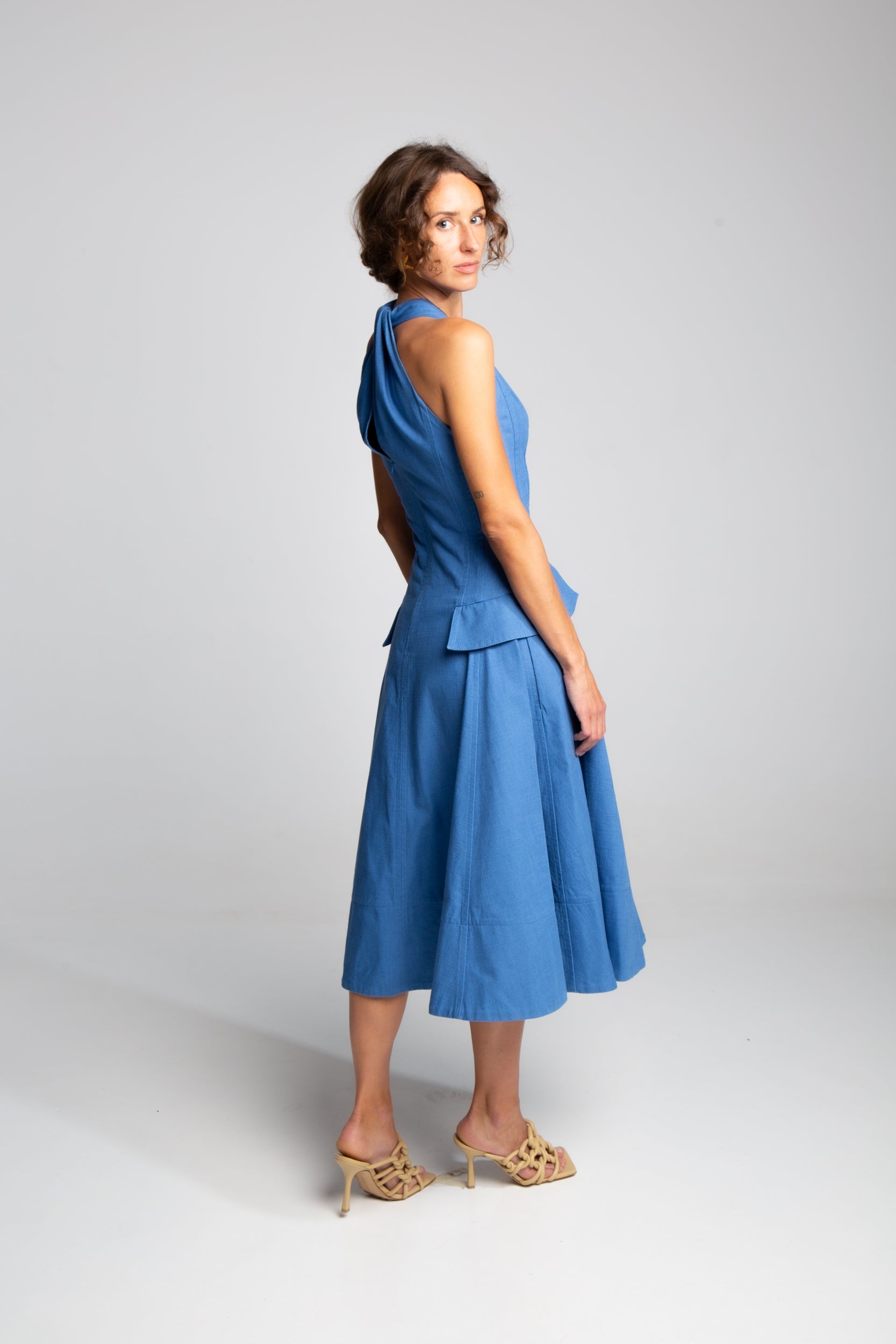 Blue A-line midi dress with halter neckline and minimalist tailoring