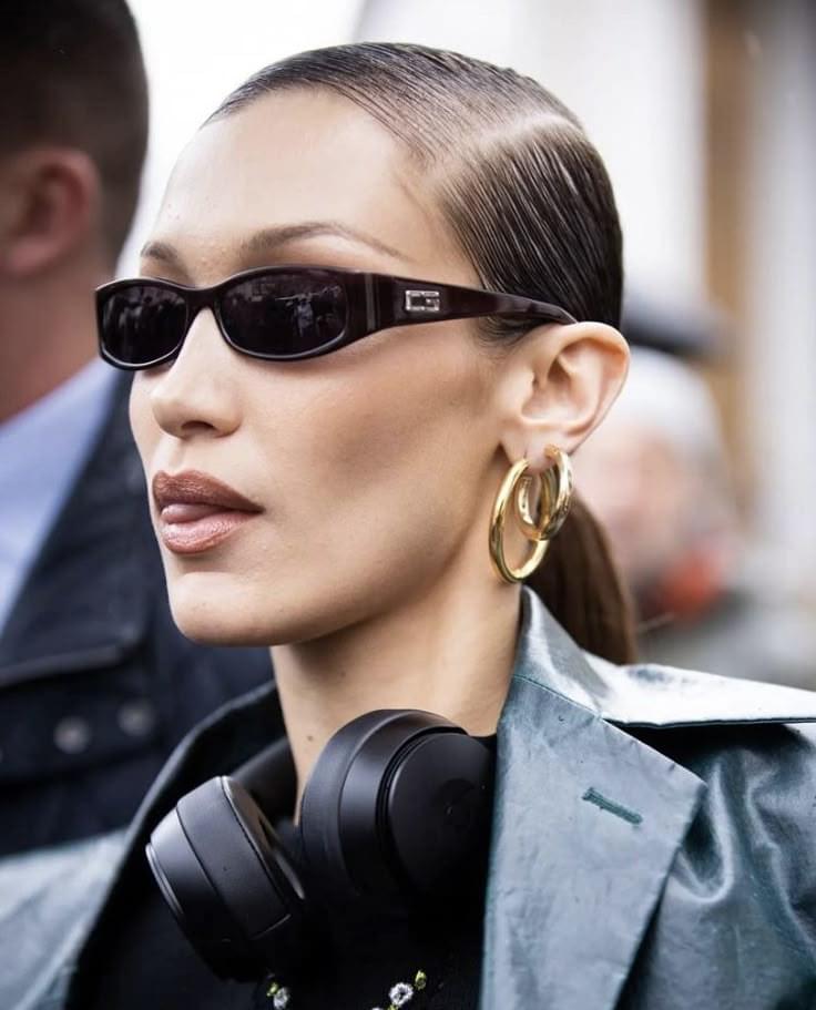 Detail view of the black oval frame and blue lens tint on archival vintage Gucci sunglasses worn by Bella Hadid available at mezzanotte