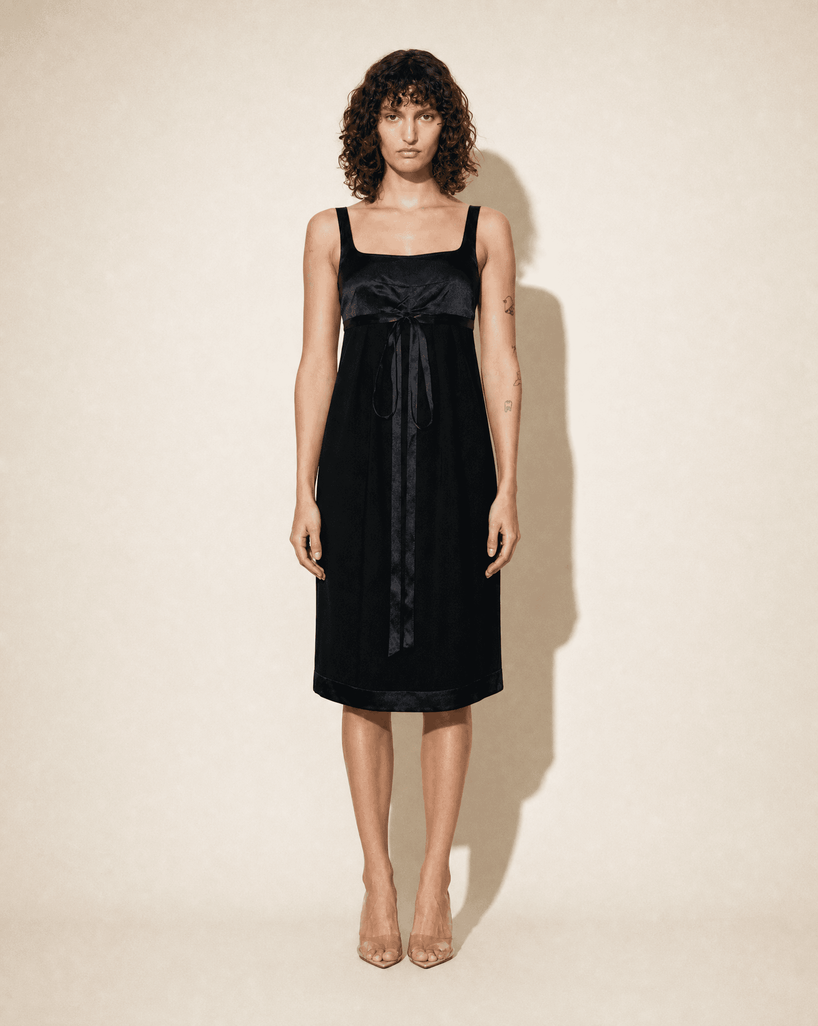 Front view of the archival Chanel Little Black Dress from the Cruise 2010 collection, featuring a square neckline and delicate front ribbon detail.