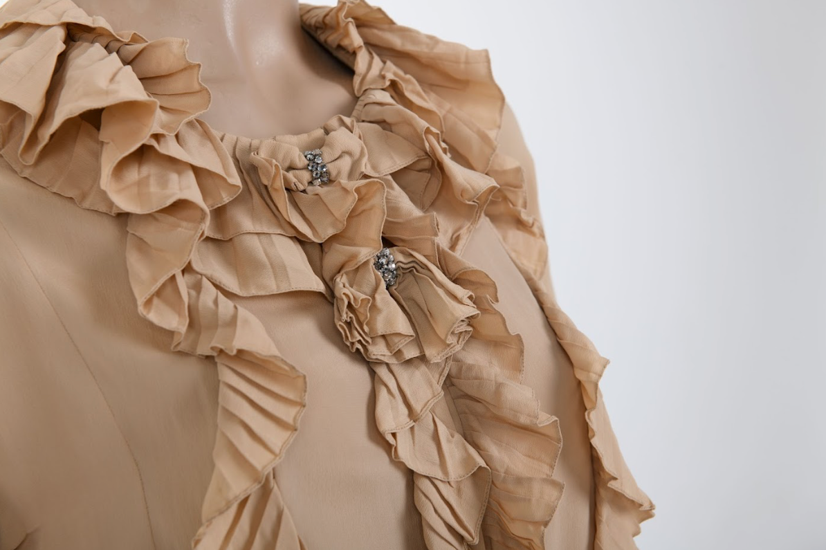 Close-up of the Chloé ruffled silk blouse highlighting the delicate silk-chiffon layers and the Victorian-inspired ruffle craftsmanship.
