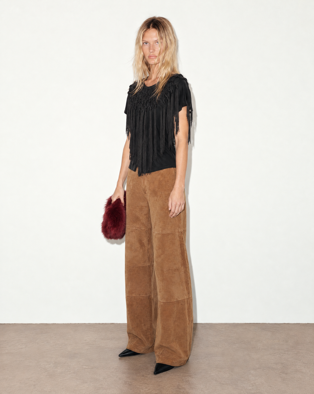 Close-up of the top’s cascading black fringe, hand-knotted across the neckline and shoulders for texture and movement.