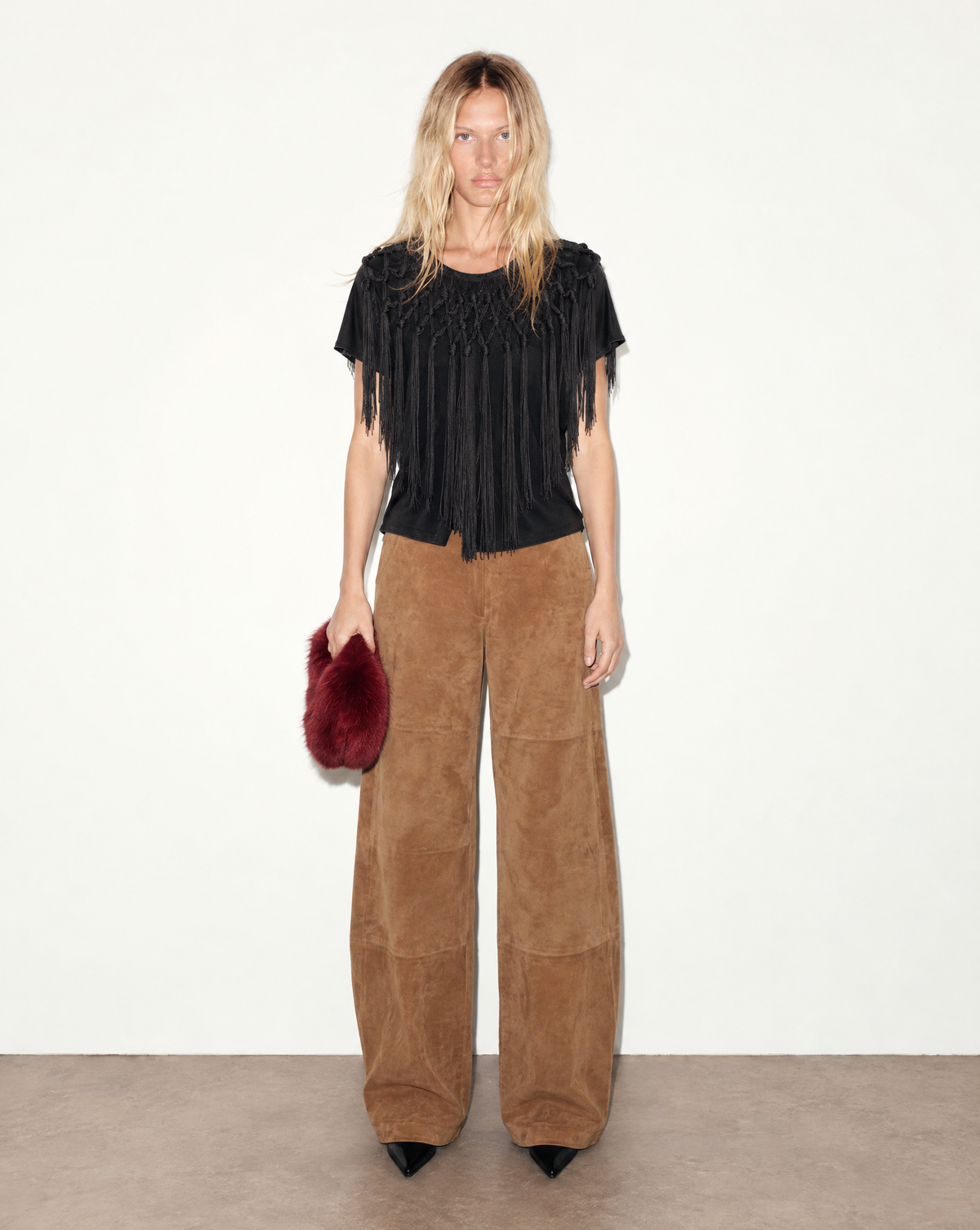 Archival Dolce & Gabbana black top from the early 2000s, crafted from a 60% silk and 40% cotton blend. Hand-knotted fringe frames the neckline and shoulders.