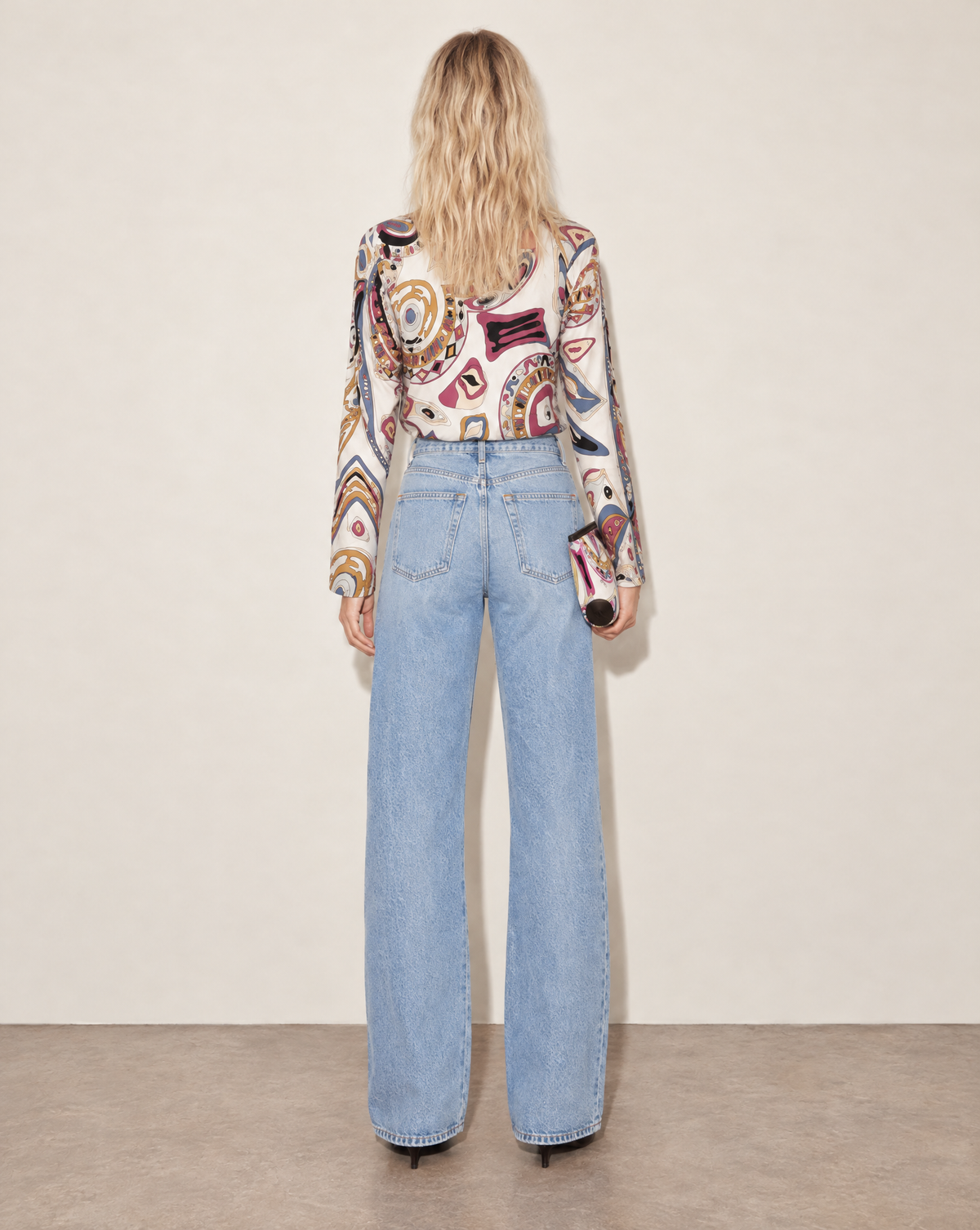 Vintage Emilio Pucci silk jersey top with a softly fitted silhouette, wide rounded neckline and three-quarter sleeves. Its bold abstract print reflects the House’s signature use of colour and pattern.