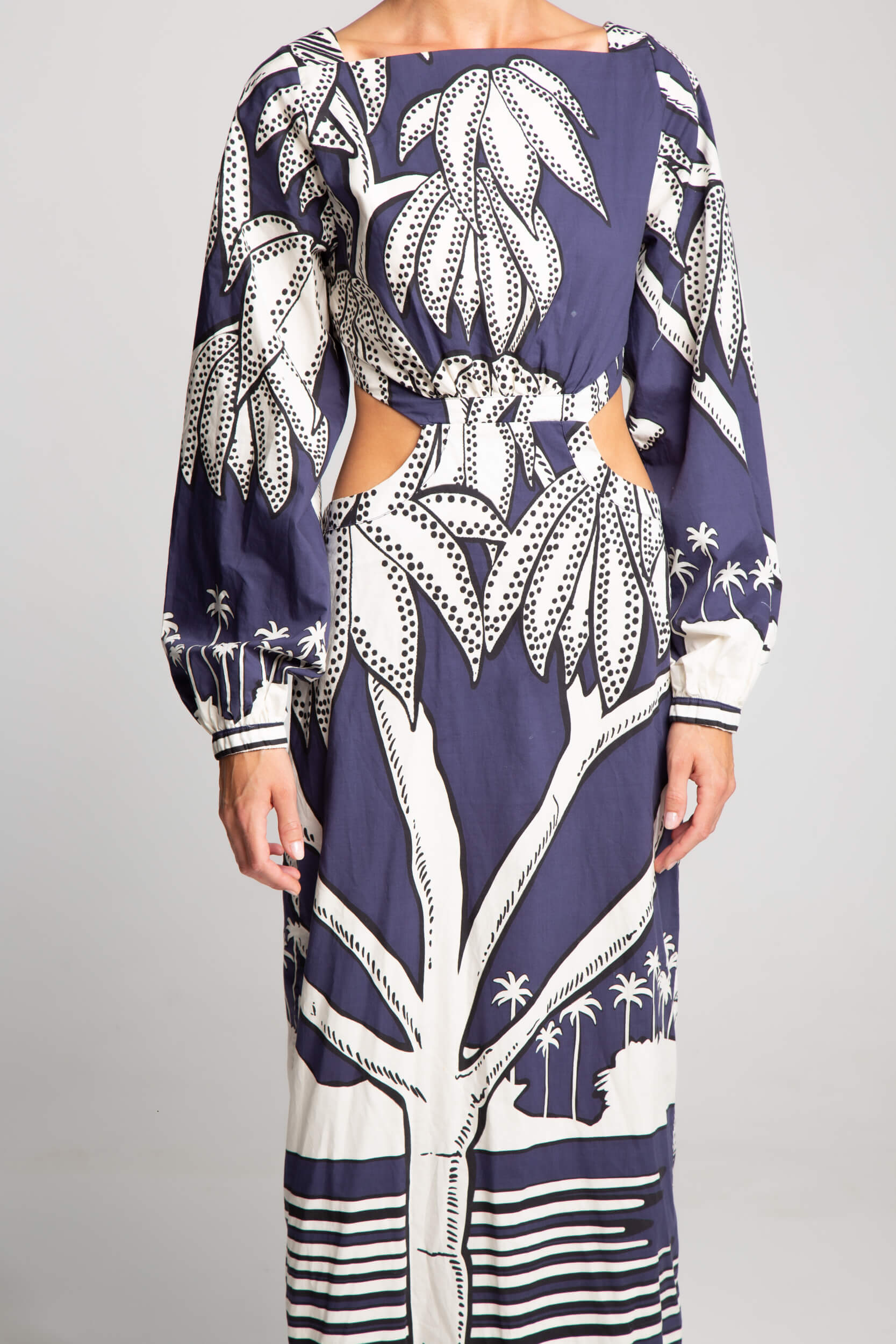 Navy and ivory palm print dress with long sleeves and sculptural cut-out silhouette
