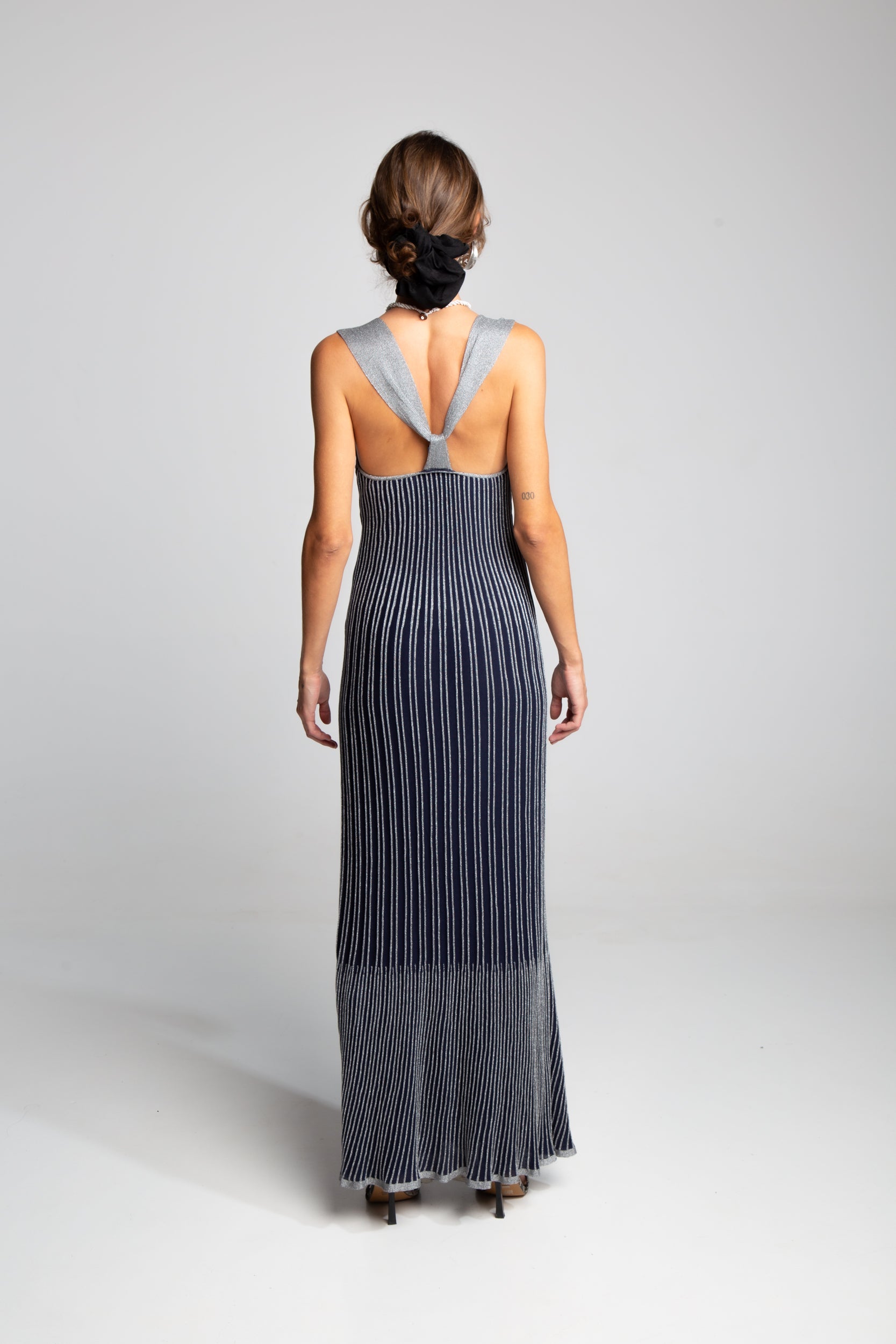 Designer knit maxi dress with deep neckline and sleek silhouette
