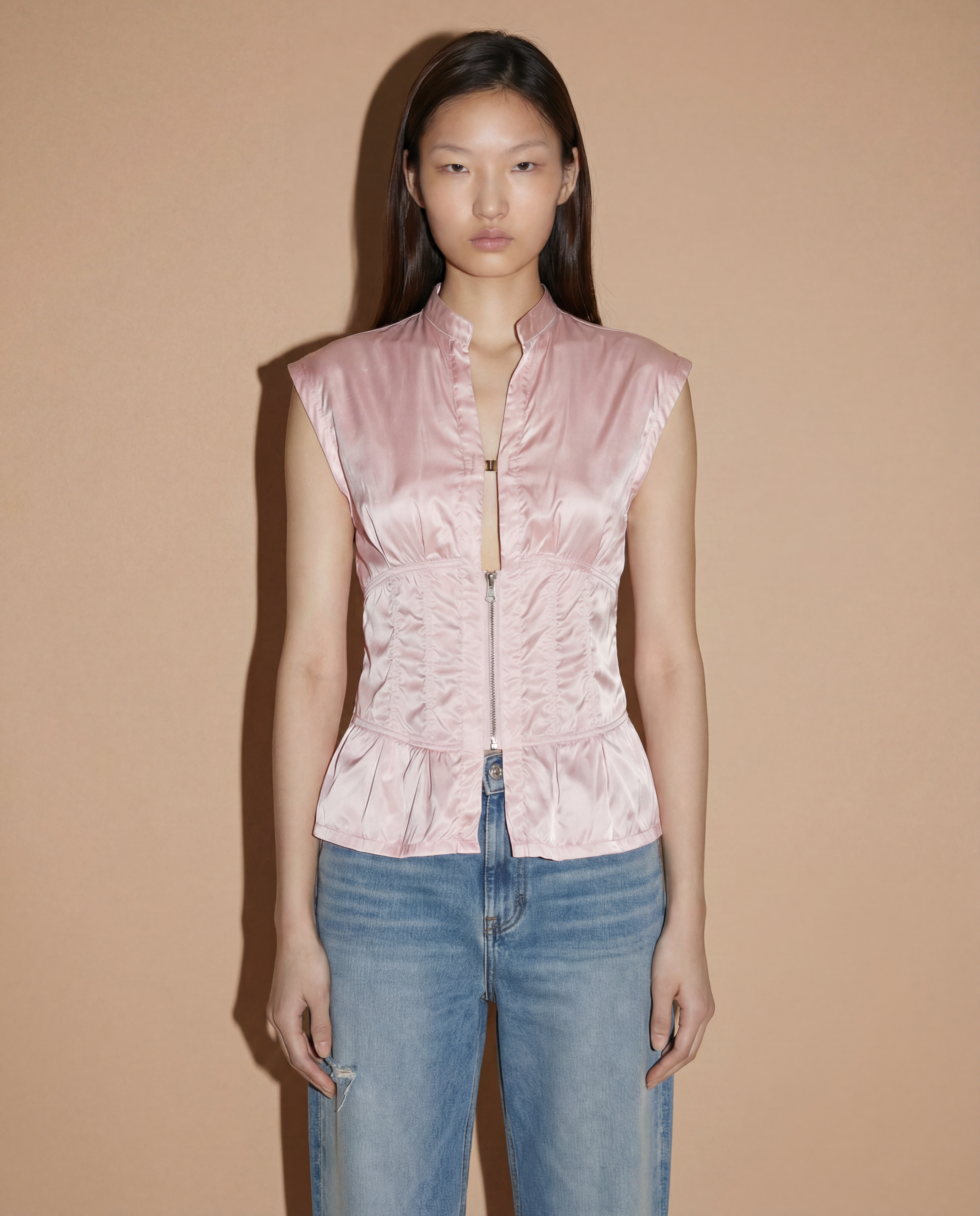 Front view of the Prada Sport corset-style top in blush pink featuring a structured zip closure and minimalist 90s silhouette.