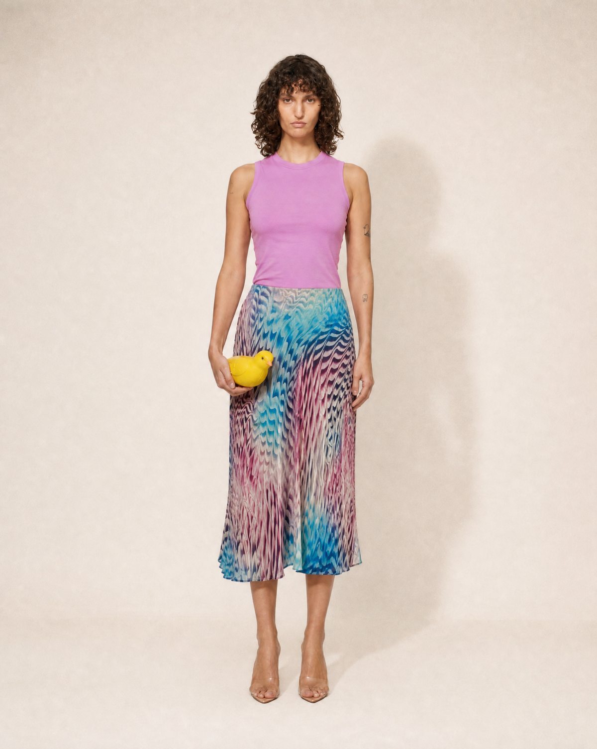 Shop this archival Roberto Cavalli silk set at Mezzanotte Vintage. Attributed to Spring/Summer 2003, it pairs a multicolour abstract-print midi skirt with its matching silk headscarf.