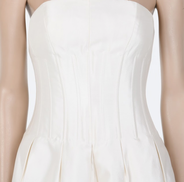 Minimalist strapless corset dress with structured pleats and modern bridal aesthetic Mezzanotte Madrid