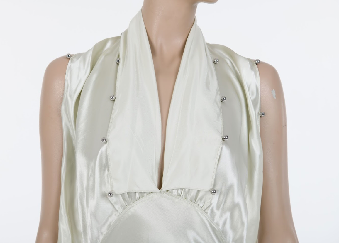 Light green midi dress with layered ruffles and minimalist luxury aesthetic
