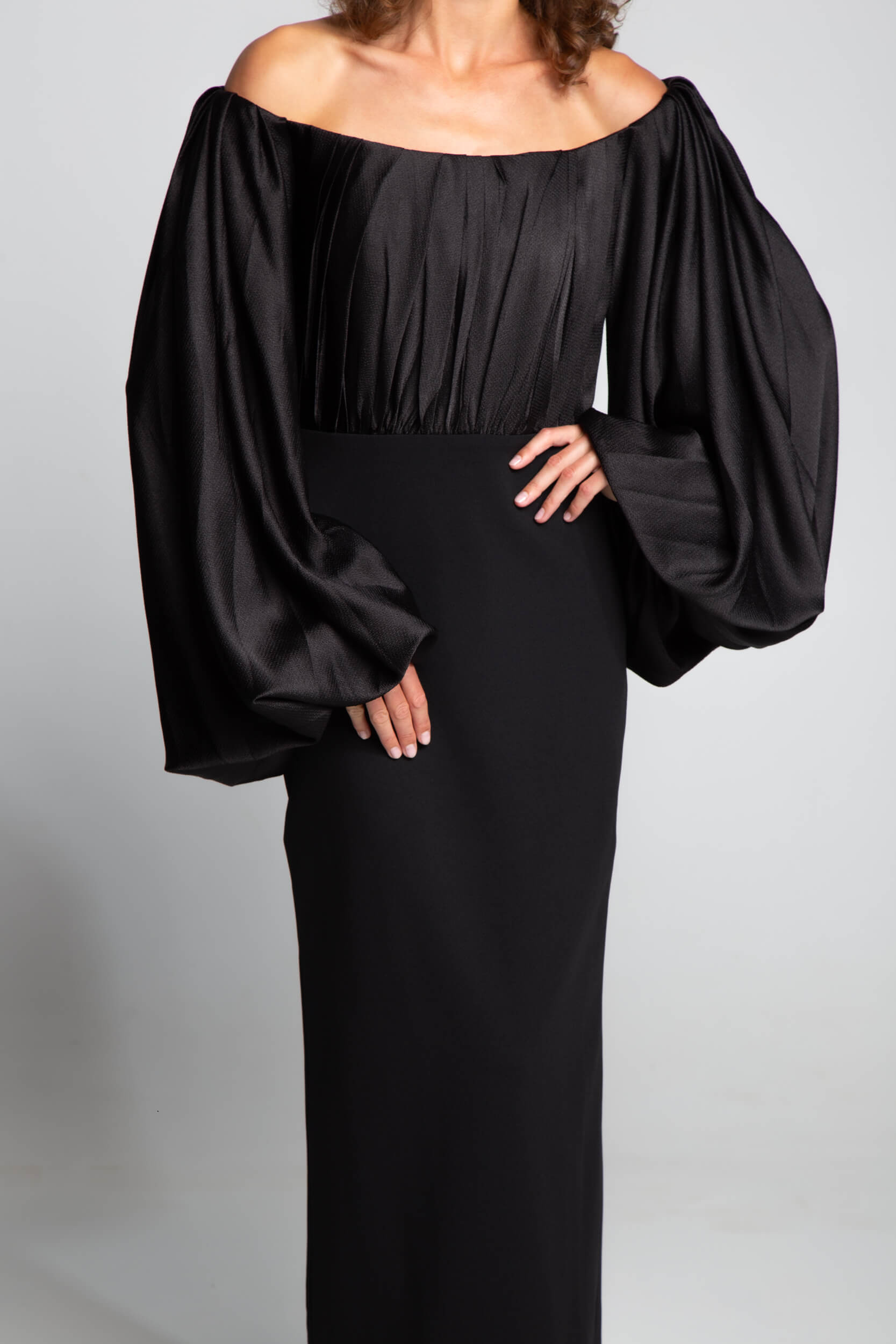 Elegant black evening gown with off shoulder cut and statement sleeves refined formal styling