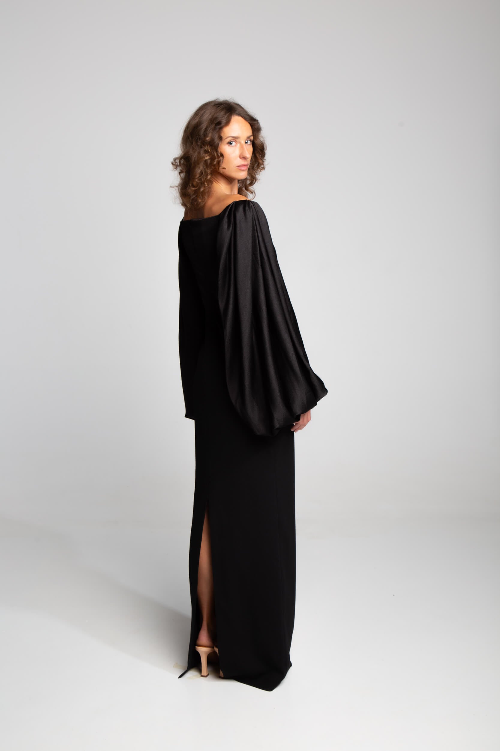 Black column dress with voluminous top and streamlined skirt modern architectural silhouette