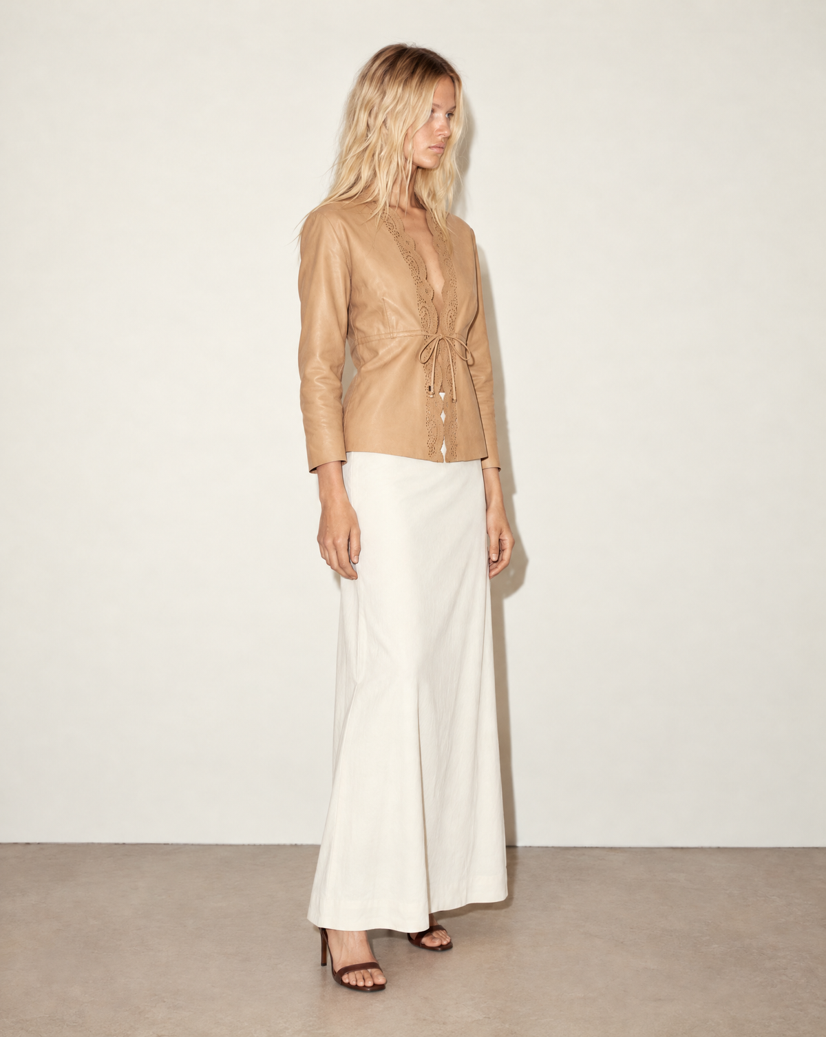 Close-up of the jacket’s laser-cut leather detailing, with a lace-like border around the neckline and front. An archival Gucci piece to buy, rent or request for a stylist pull through Mezzanotte Vintage.